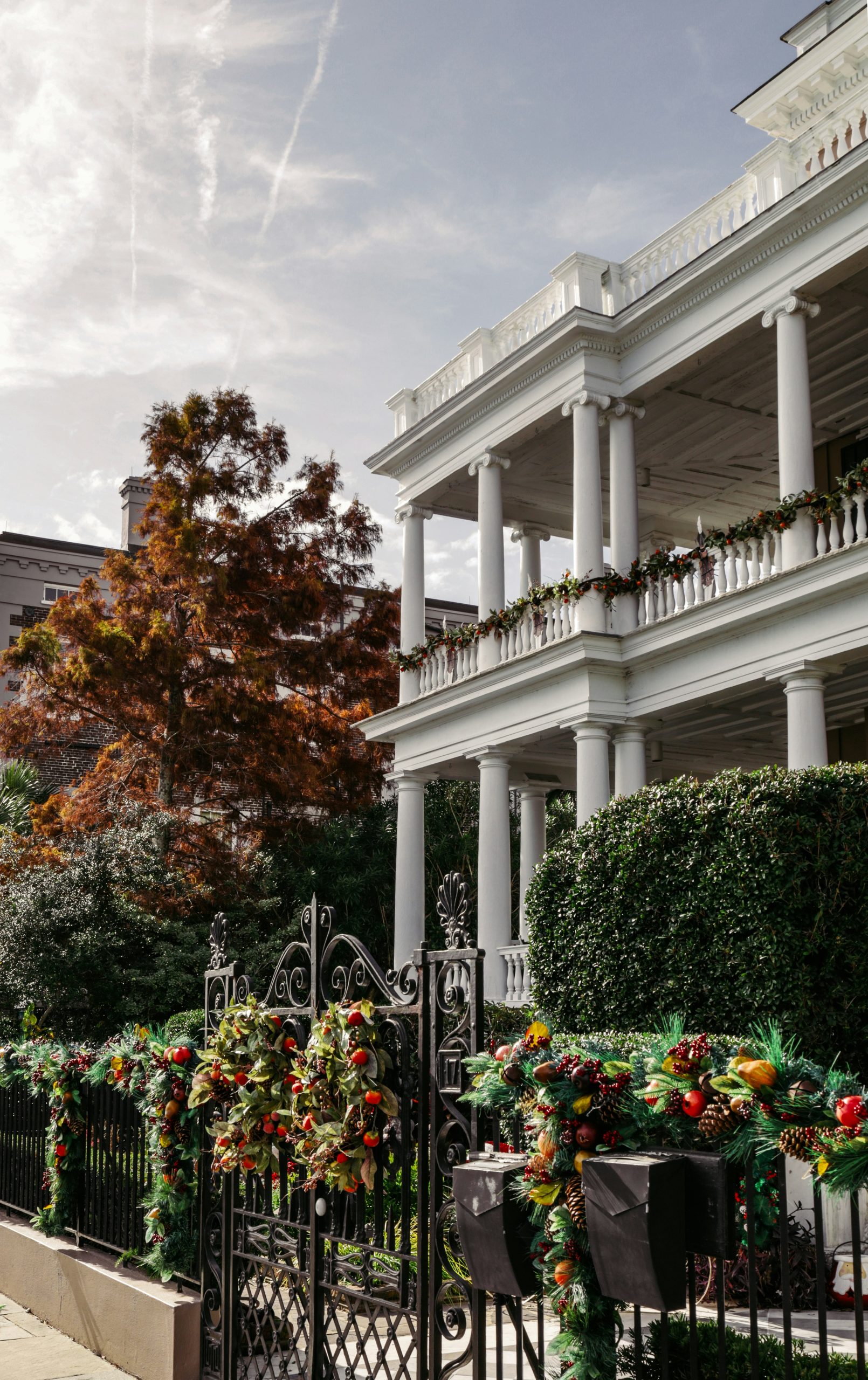 a black iron fence with a bunch of flowers on it