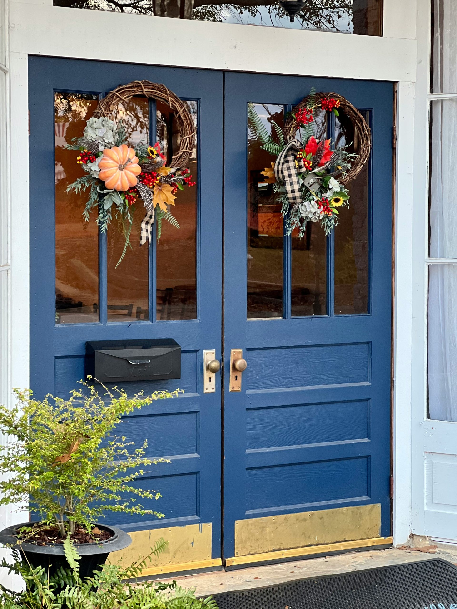 a blue door with flowers in it