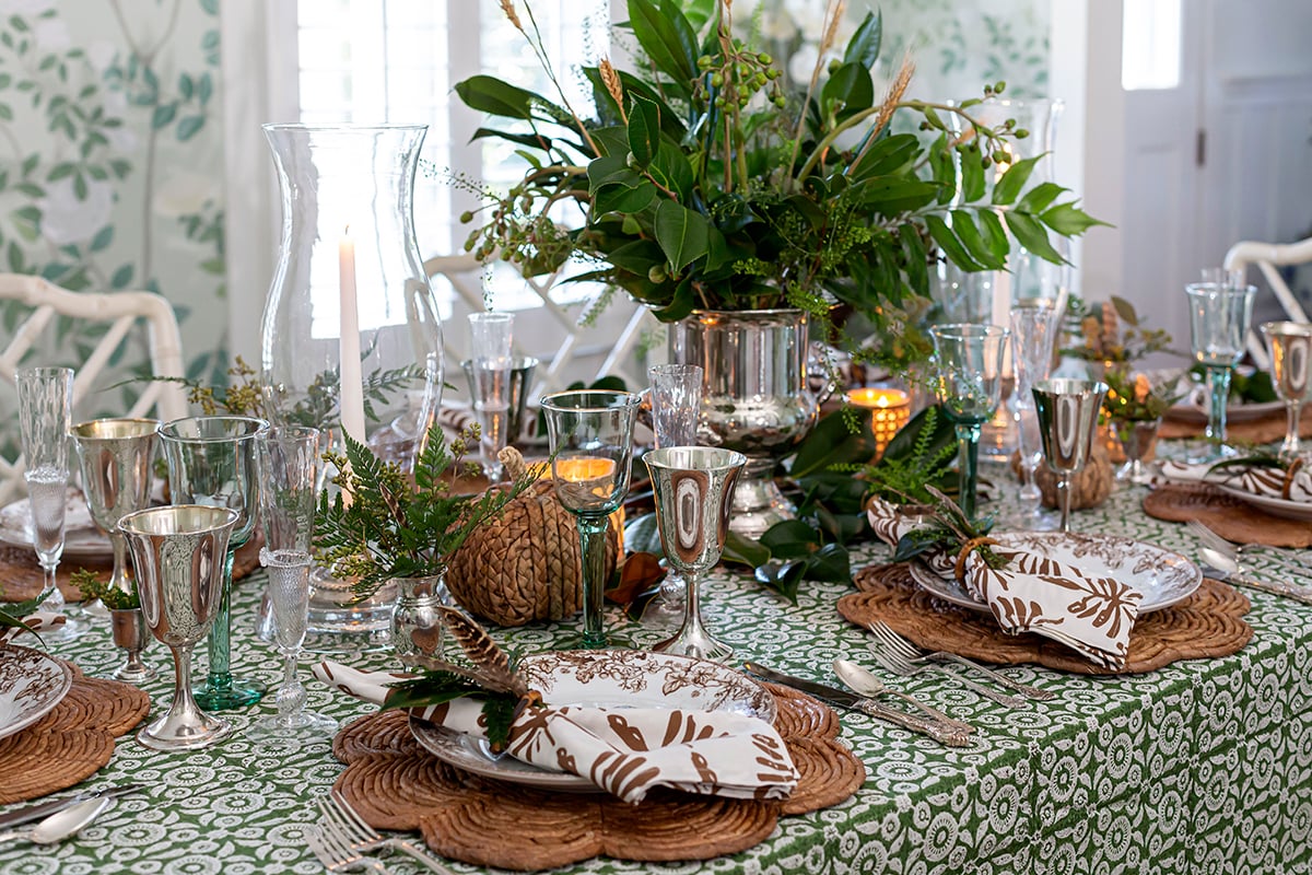 A Collected Green Thanksgiving Table with Rattan and Silver Touches - Pizzazzerie