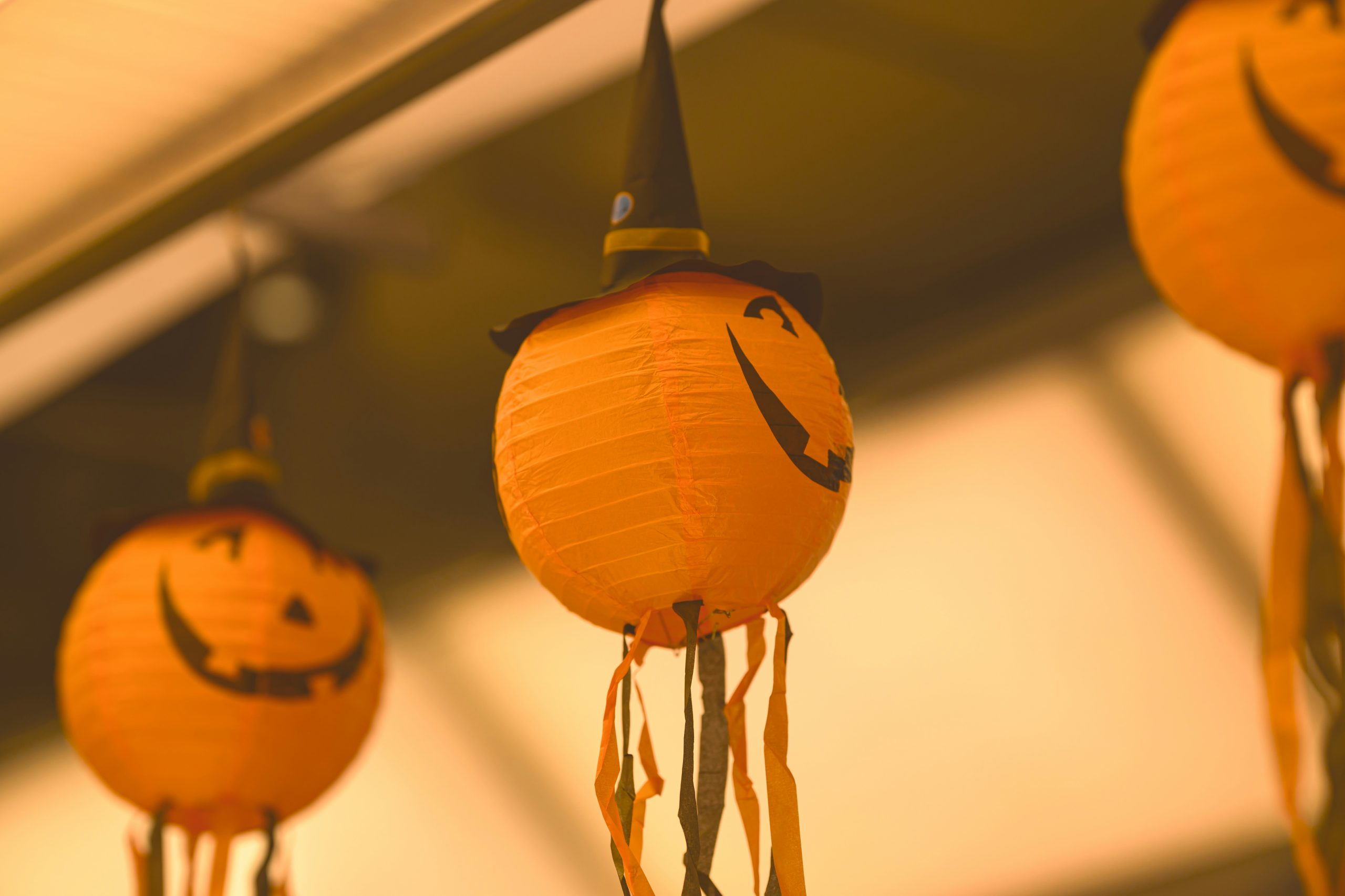 A group of orange lanterns with faces drawn on them