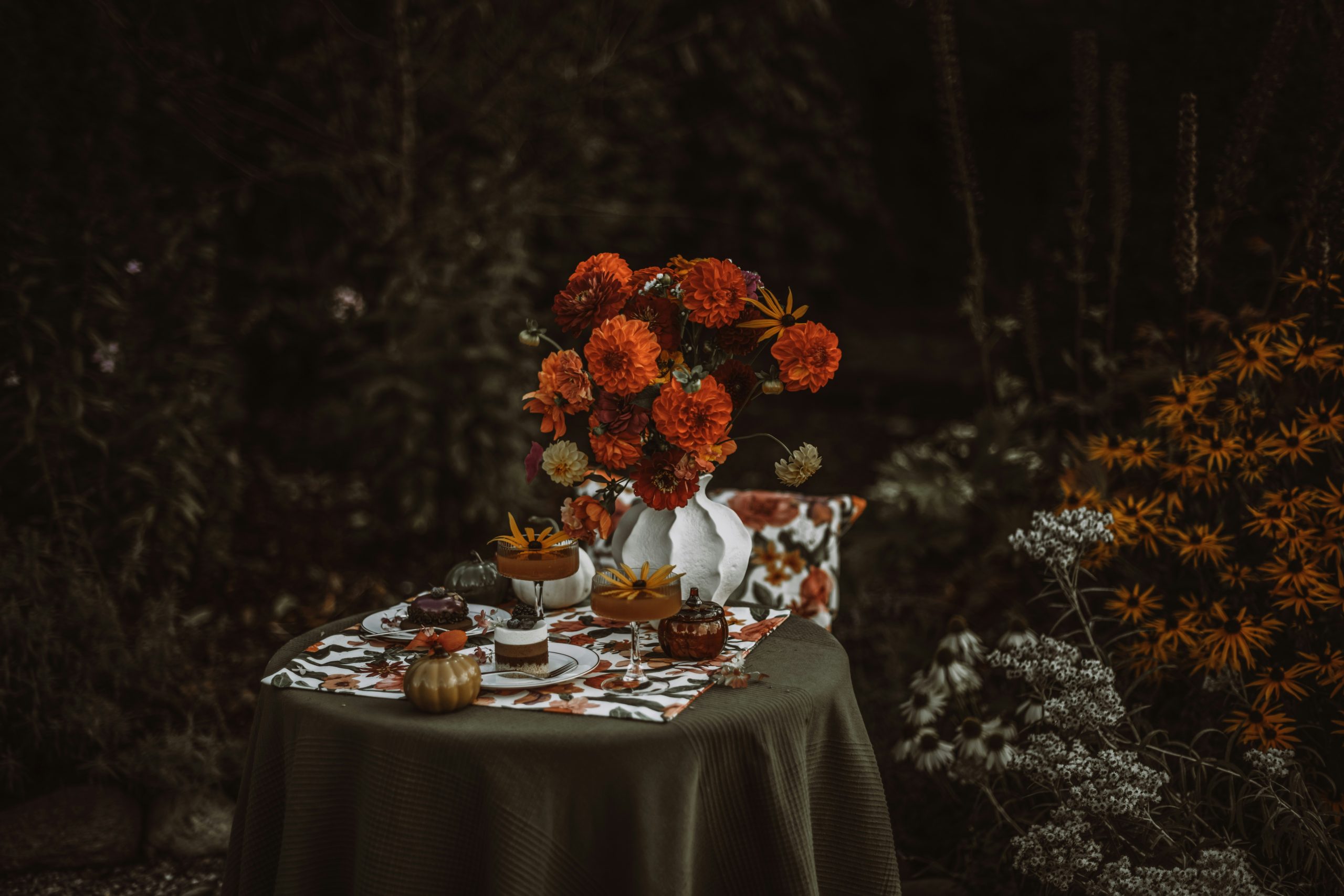 Autumn table setting with flowers and desserts