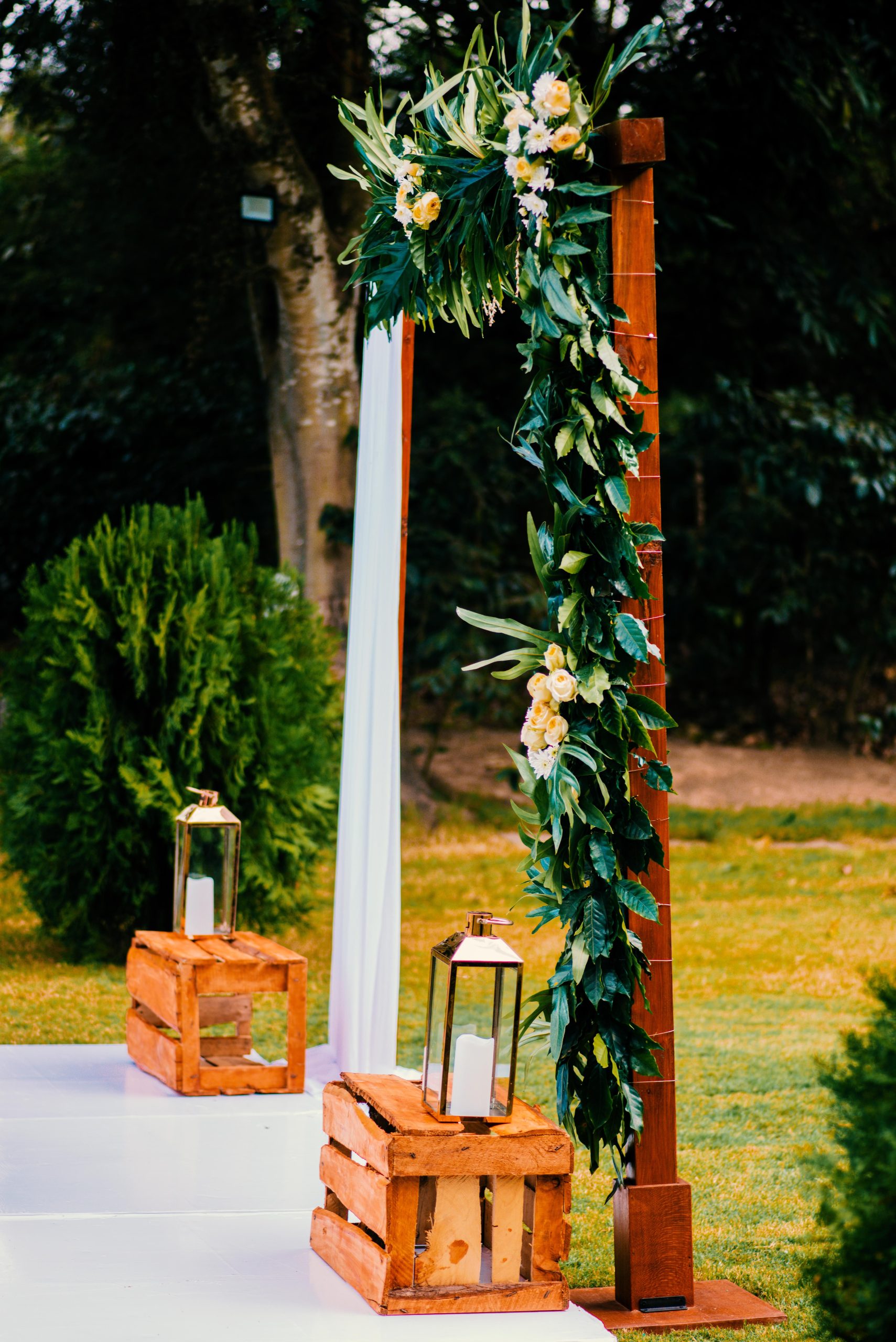 Beautiful decorated wedding arch with greenery and lanterns in Arusha, Tanzania.