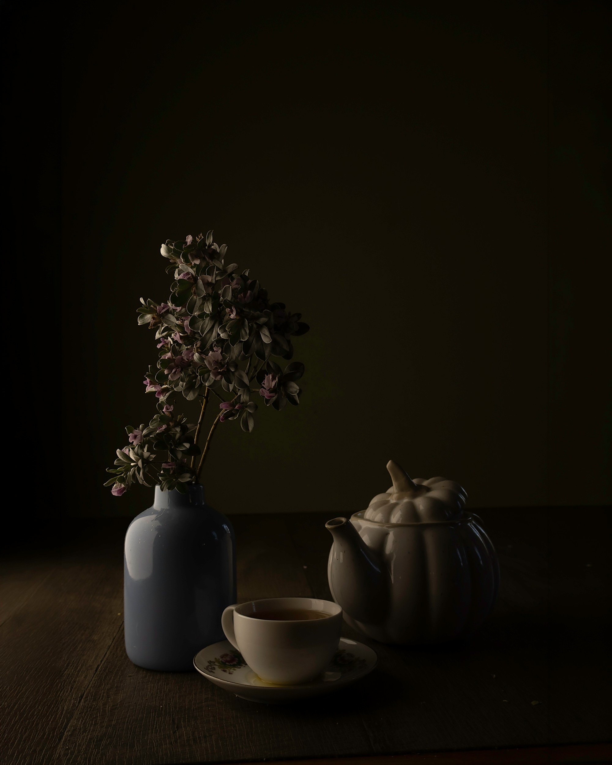 blue vase with purple flowers and tea set