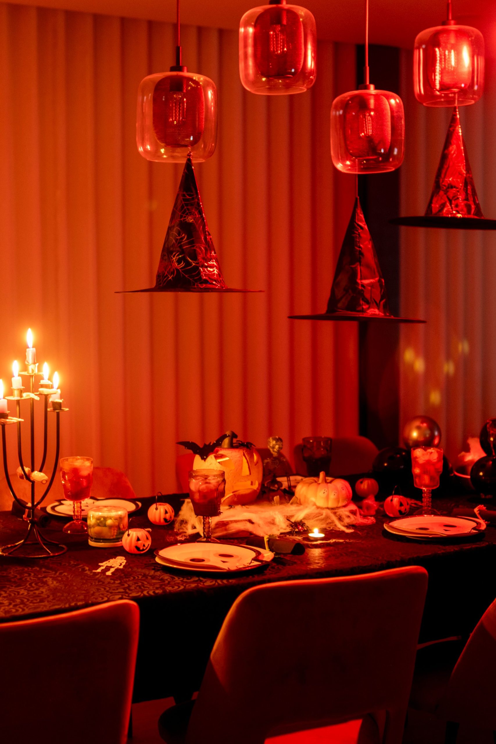 Captivating Halloween-themed table setup featuring candles, decorations, and a warm ambiance.