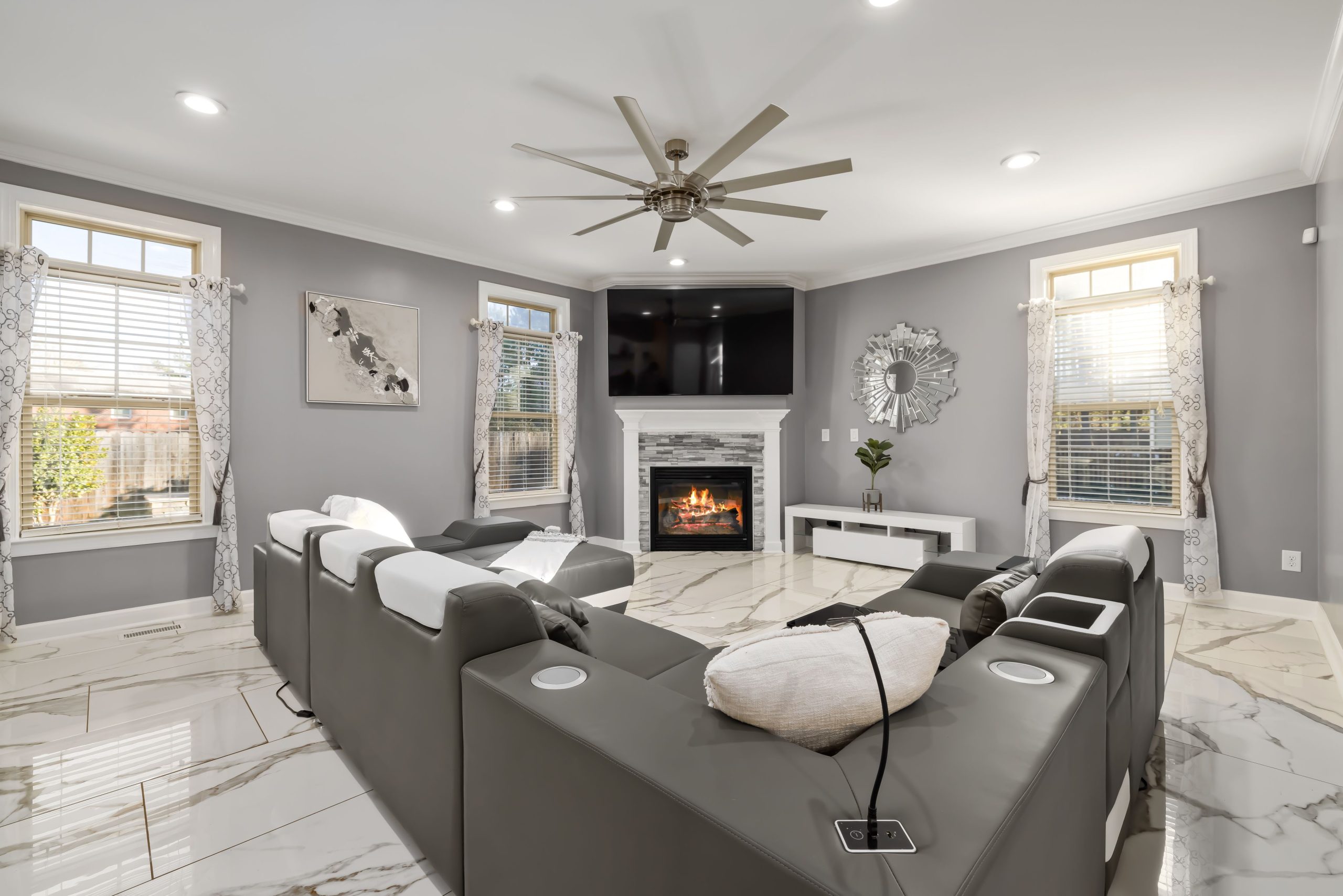 Contemporary living room featuring sleek furniture, a fireplace, and elegant decor.
