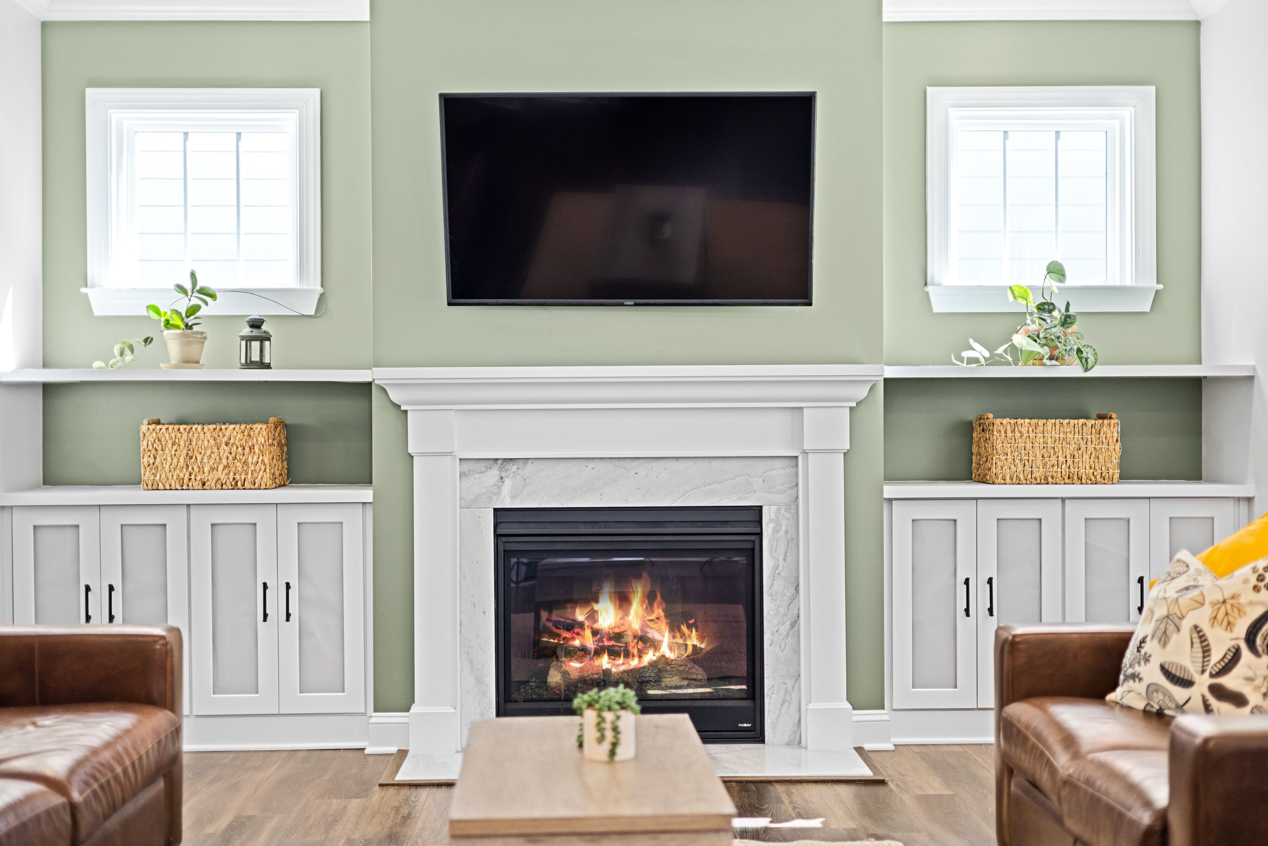 Cozy living room with a fireplace, TV, and stylish decor for a warm ambiance.