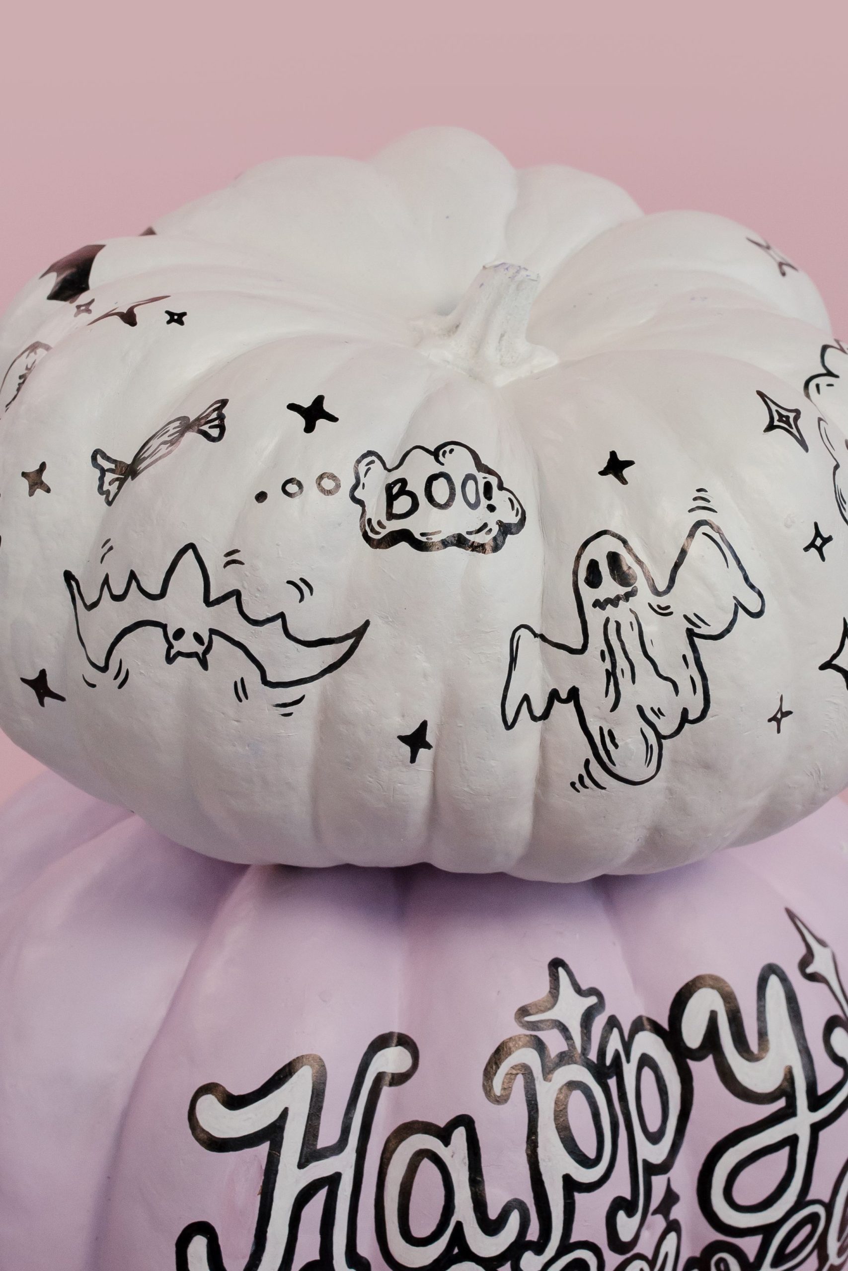 Decorative Halloween pumpkins with ghost and bat artwork for a festive touch.