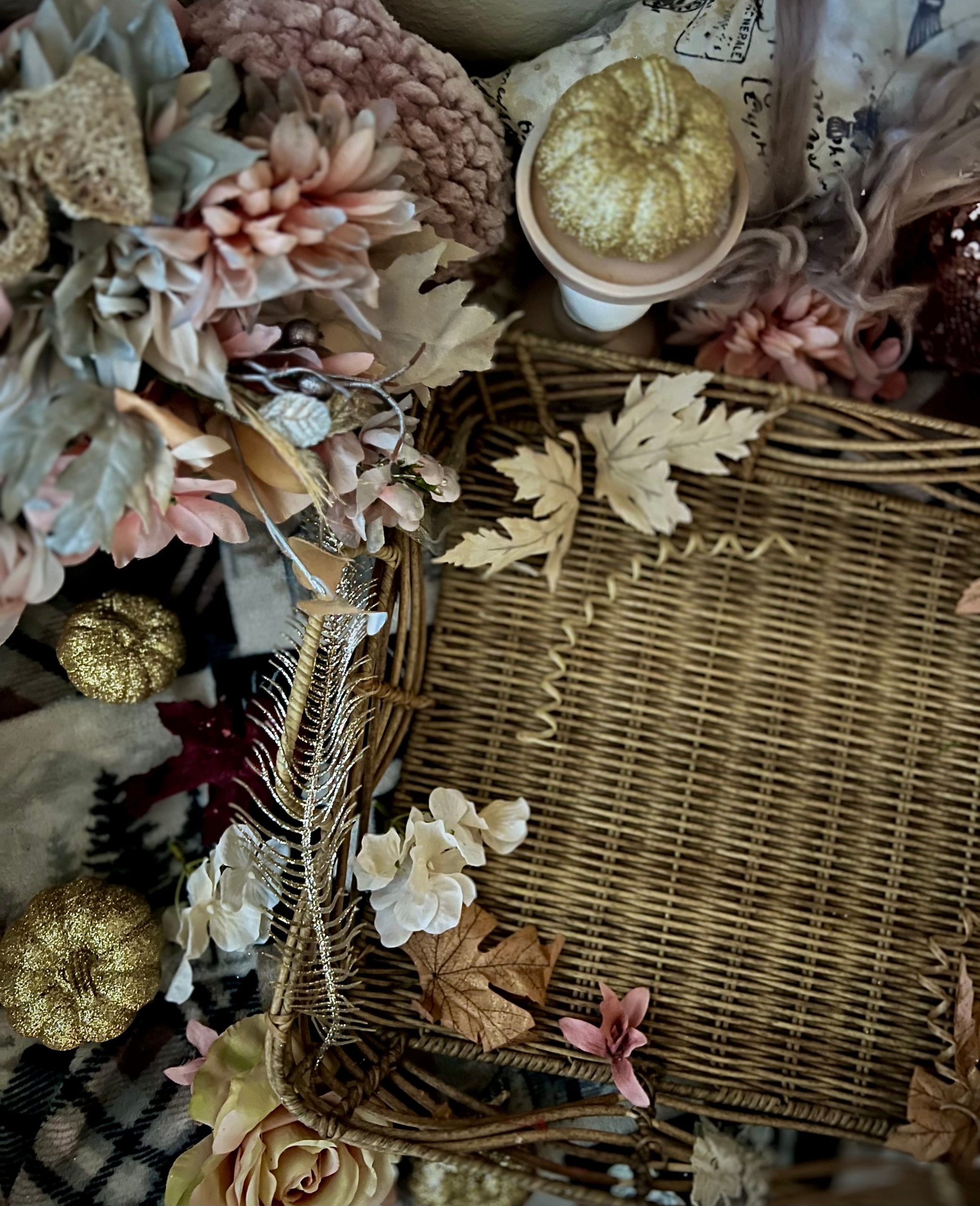 Elegant floral and pumpkin arrangement in a wicker basket, capturing the essence of autumn decor.