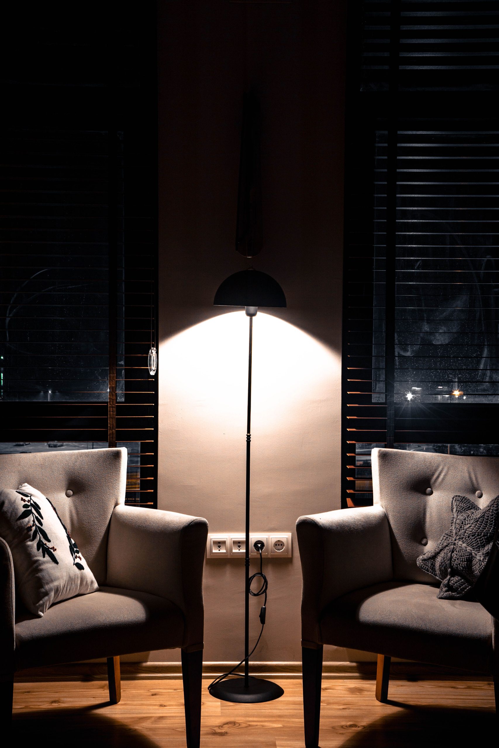 Elegant lounge with two armchairs and a floor lamp, perfect for cozy evenings.