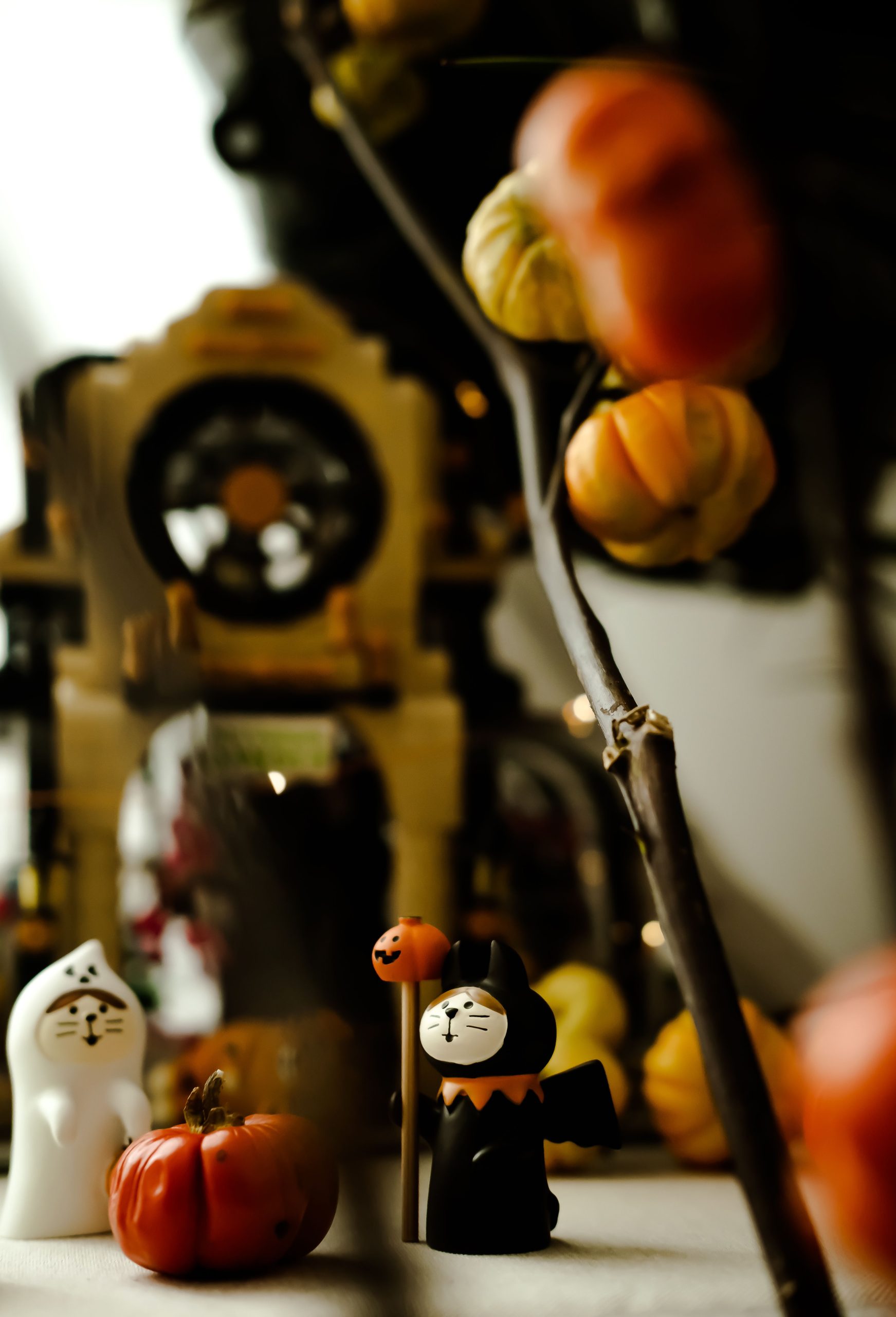 Festive Halloween setup with ceramic figurines and pumpkins. Perfect for fall decor ideas.