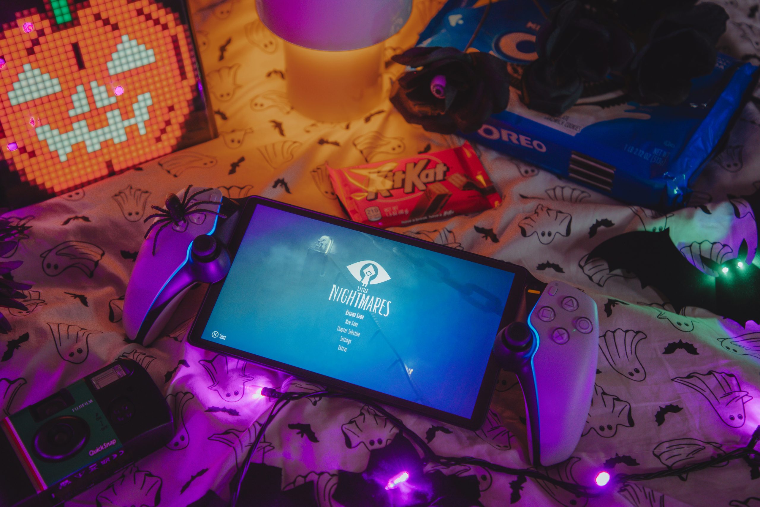 Halloween gaming setup with snacks and lights