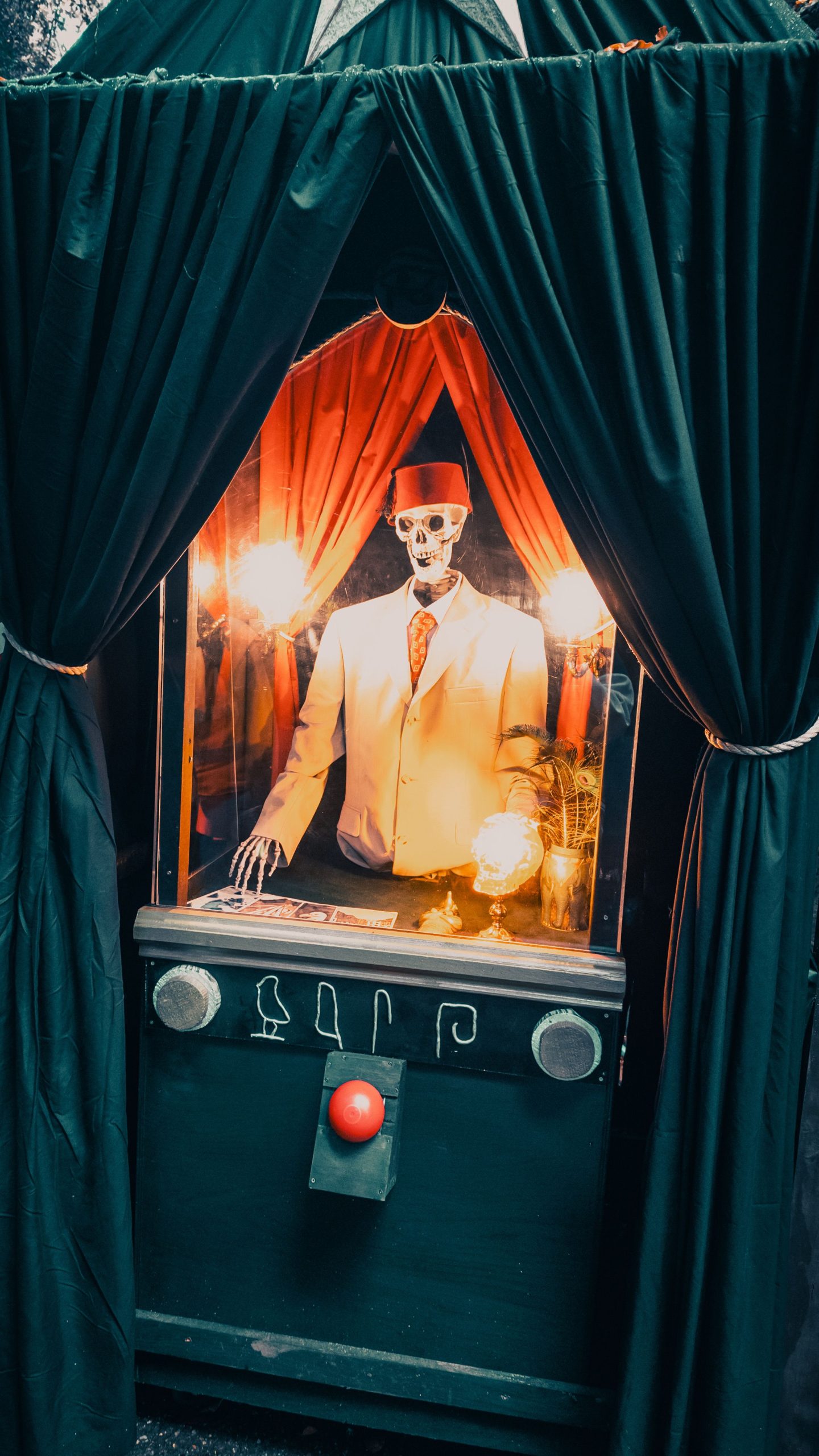 Halloween-themed fortune teller booth with skeleton in a suit, perfect for spooky decor.