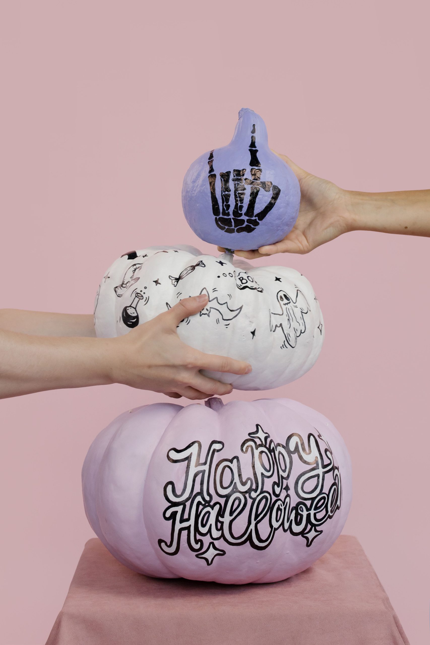 Handmade Halloween pumpkins with unique designs in a creative stacking composition.