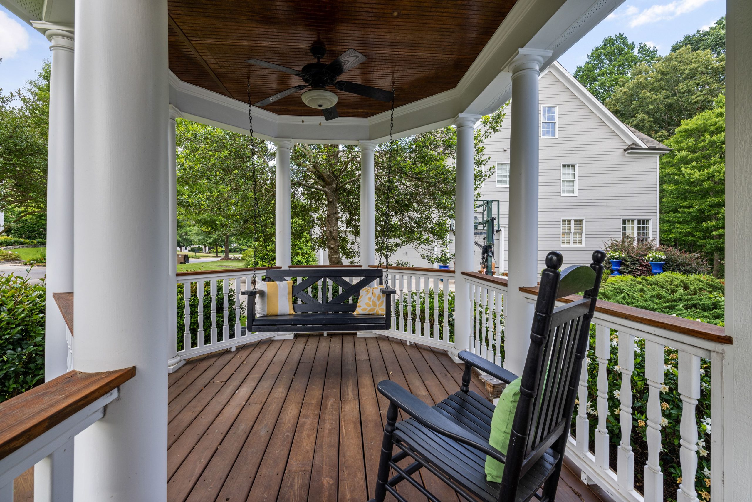 Inviting porch with rocking chair and swing, perfect for relaxation.