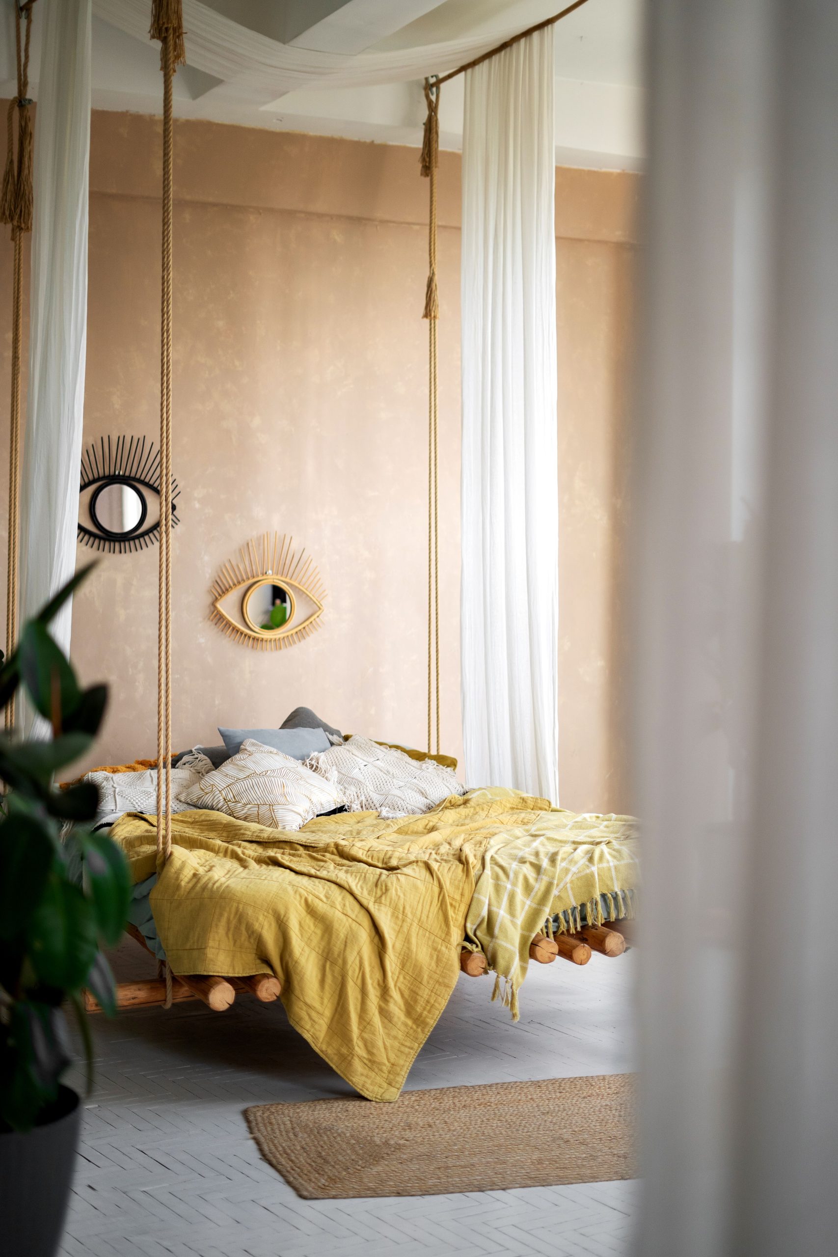 Stylish bedroom featuring a suspended bed with chic interior design elements.