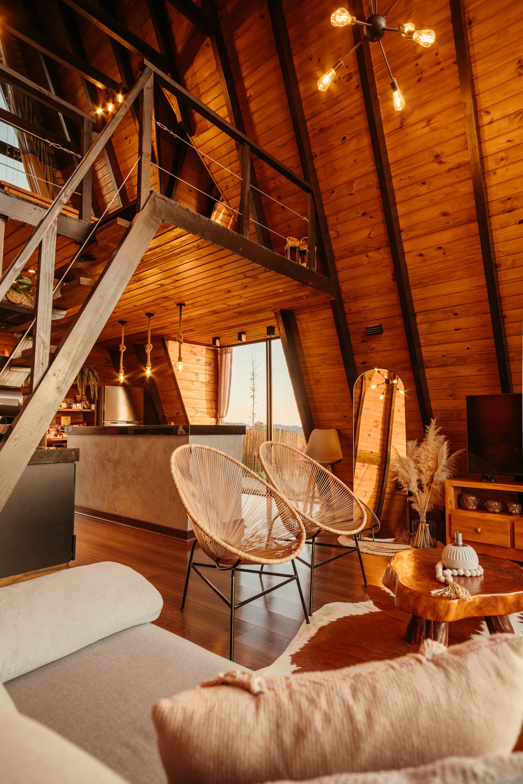 Warm and inviting A-frame cabin with rustic wooden decor and modern furnishings.