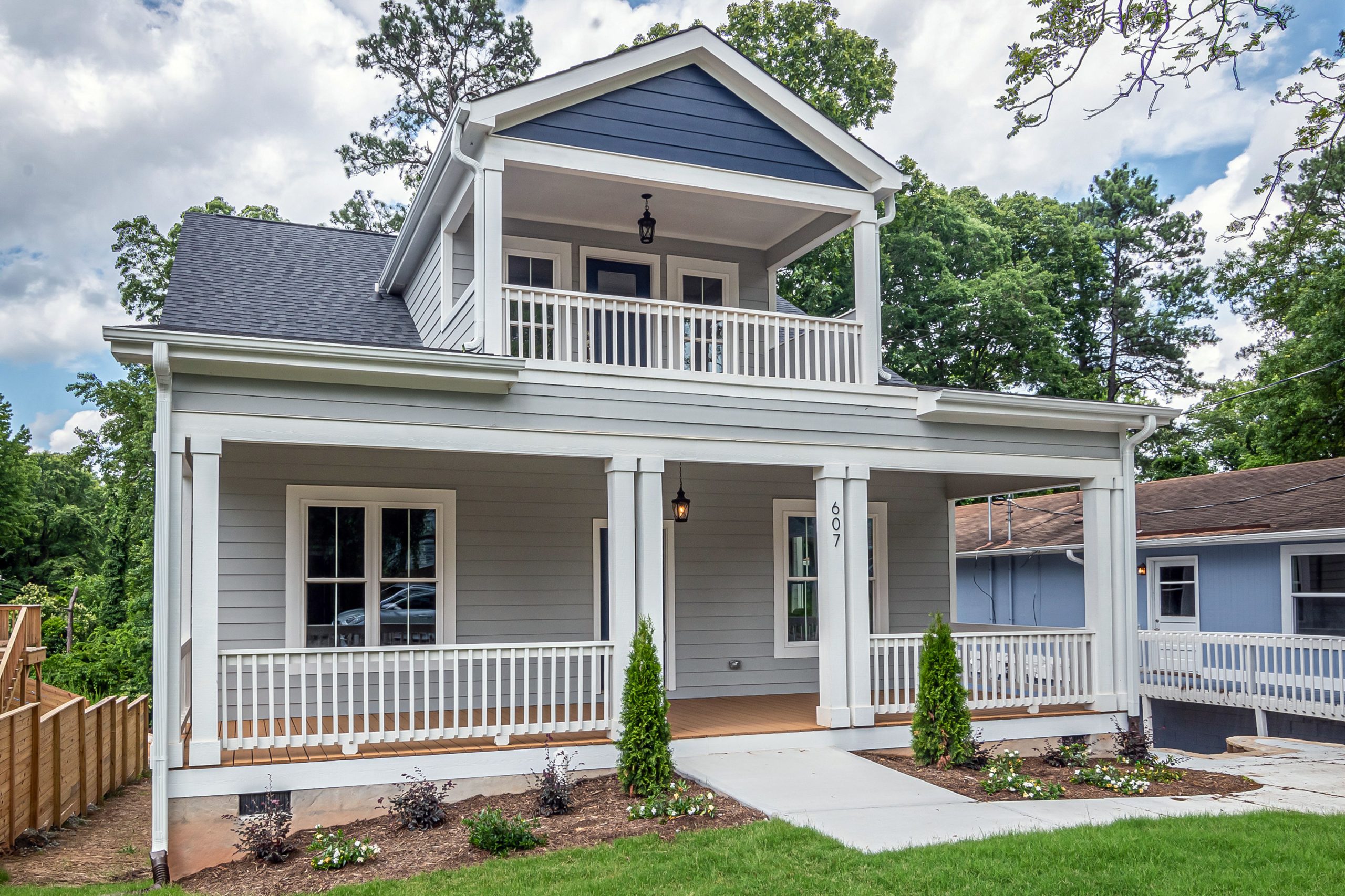 A beautiful suburban home featuring classic architecture and a well-maintained front yard.