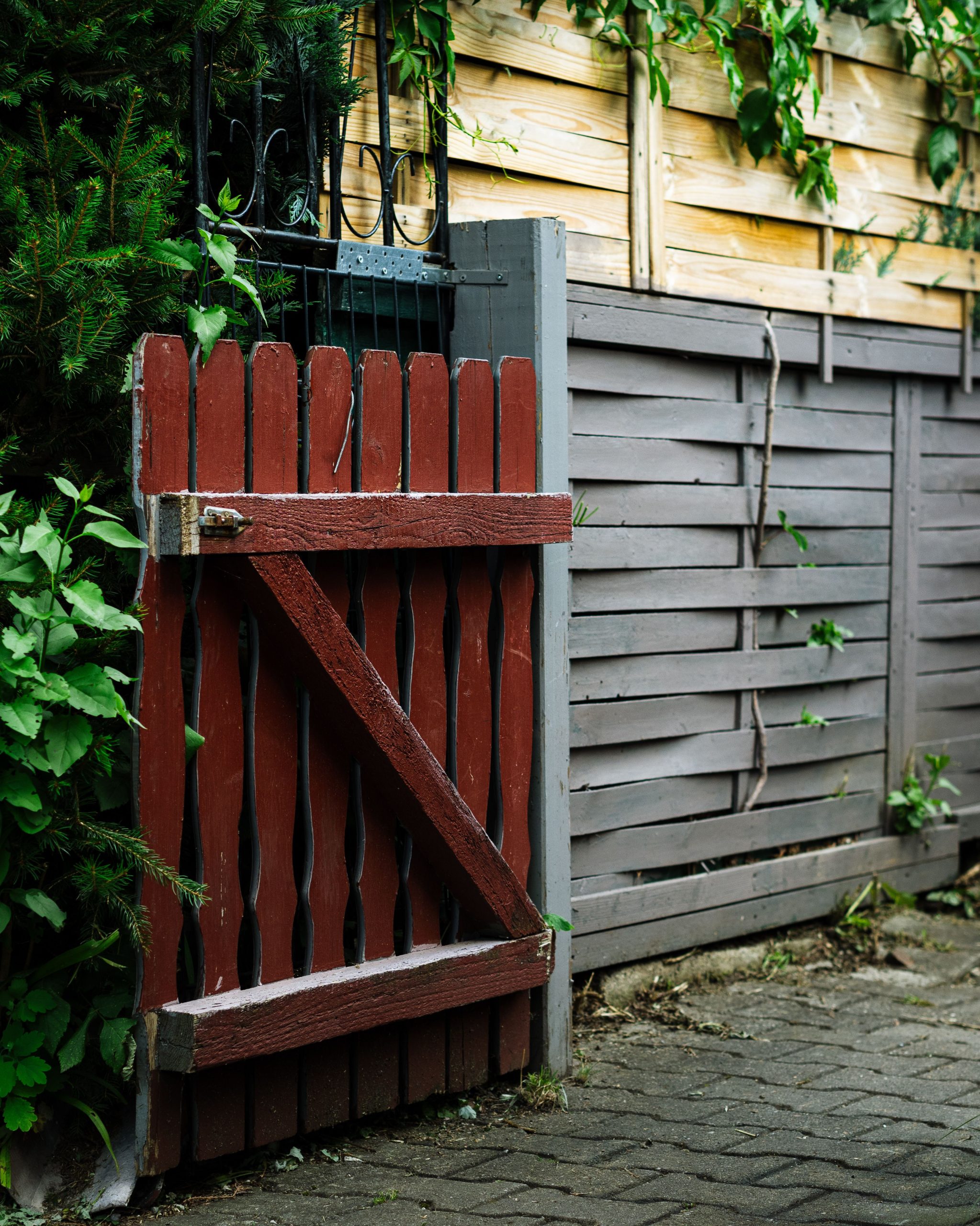 A charming rustic wooden gate with vibrant foliage, creating a picturesque garden entrance.