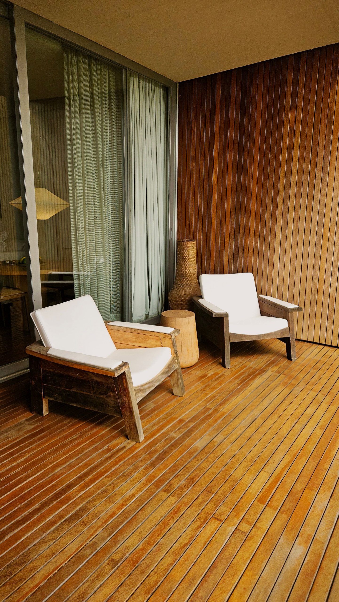 A contemporary wooden deck with stylish wooden lounge chairs for relaxation.