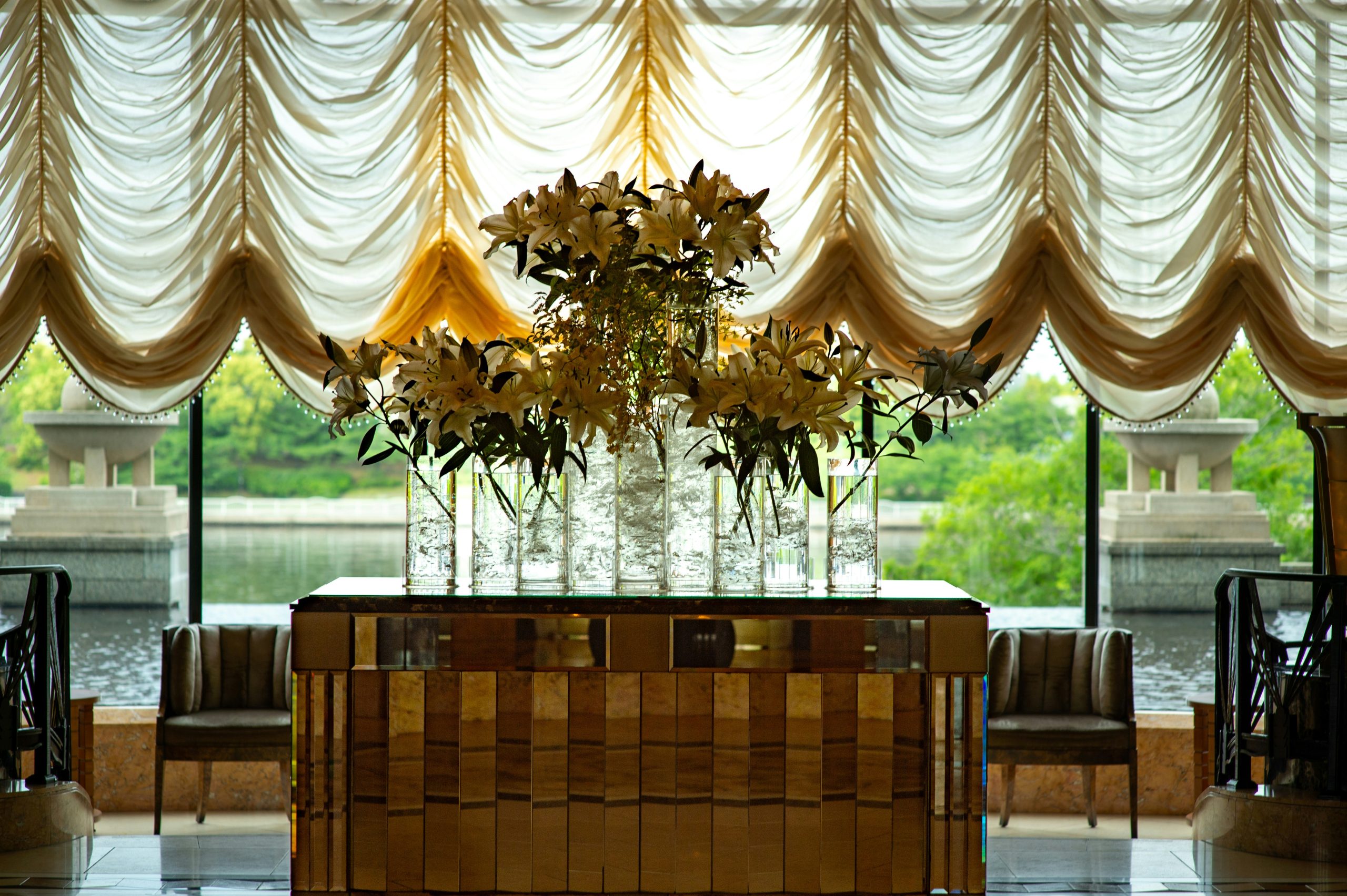 A floral arrangement in a luxurious room overlooking water