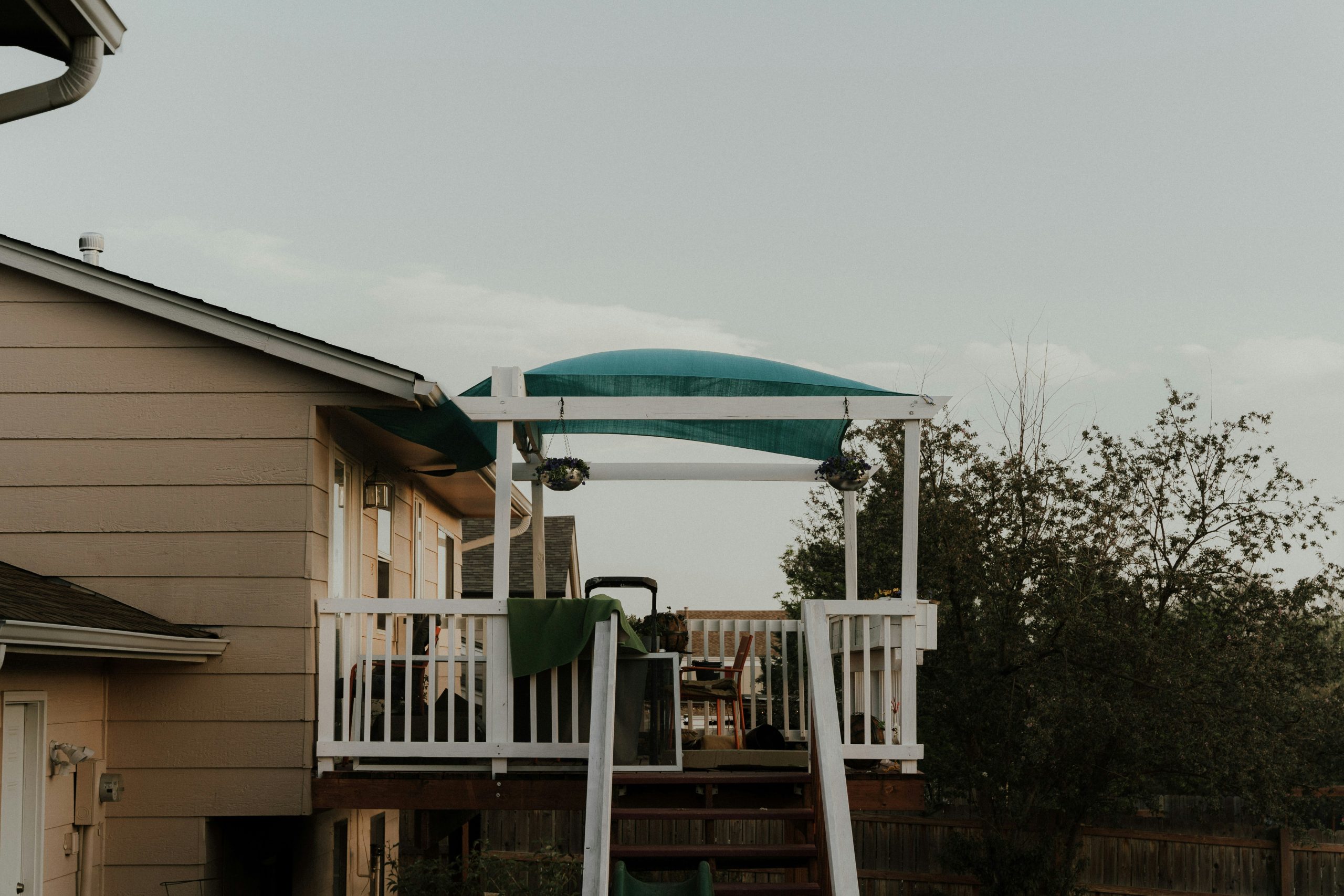 a house with a deck and a green awning
