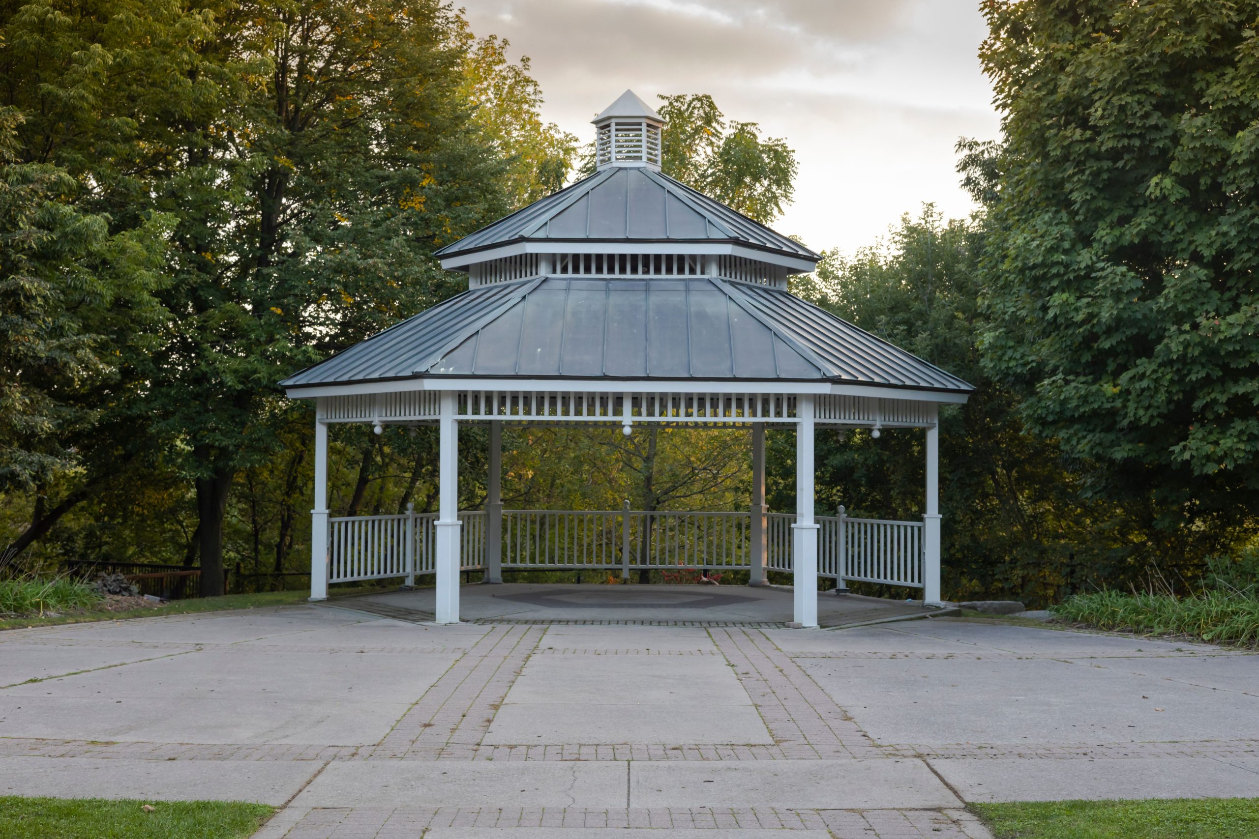 A picturesque gazebo surrounded by trees in an outdoor park, ideal for relaxation.