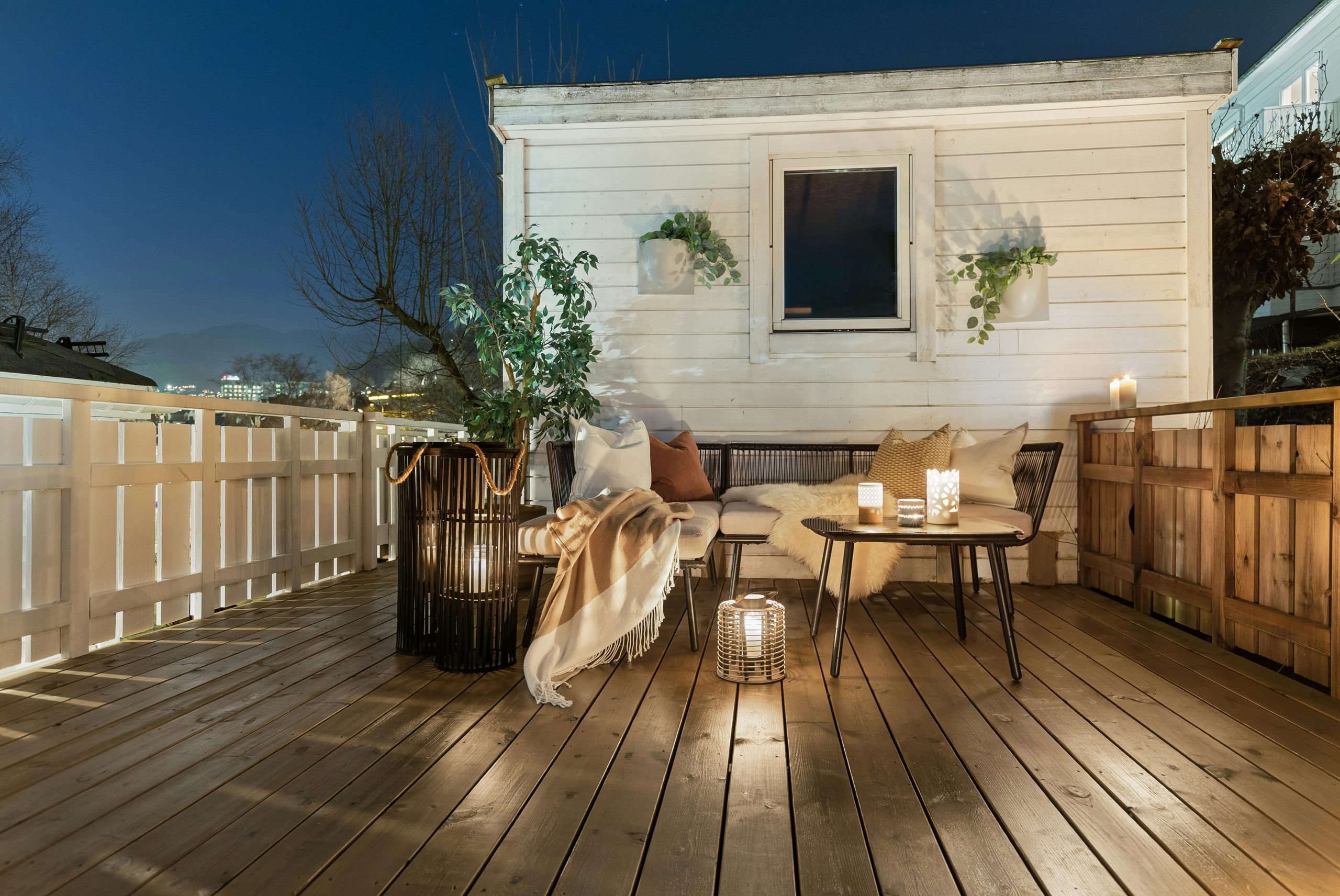 A wooden deck with a table and chairs