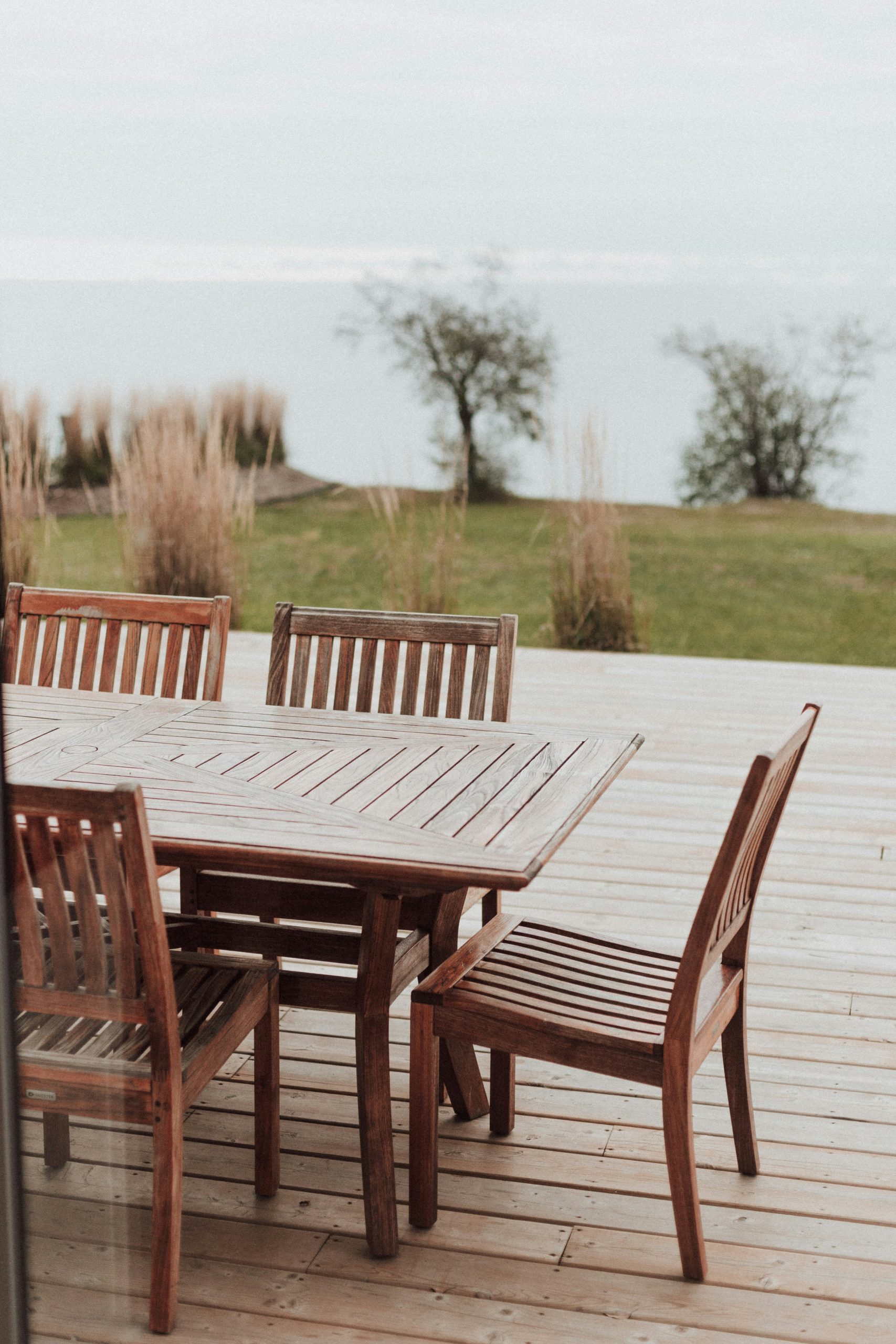 A wooden table and chairs on a deck