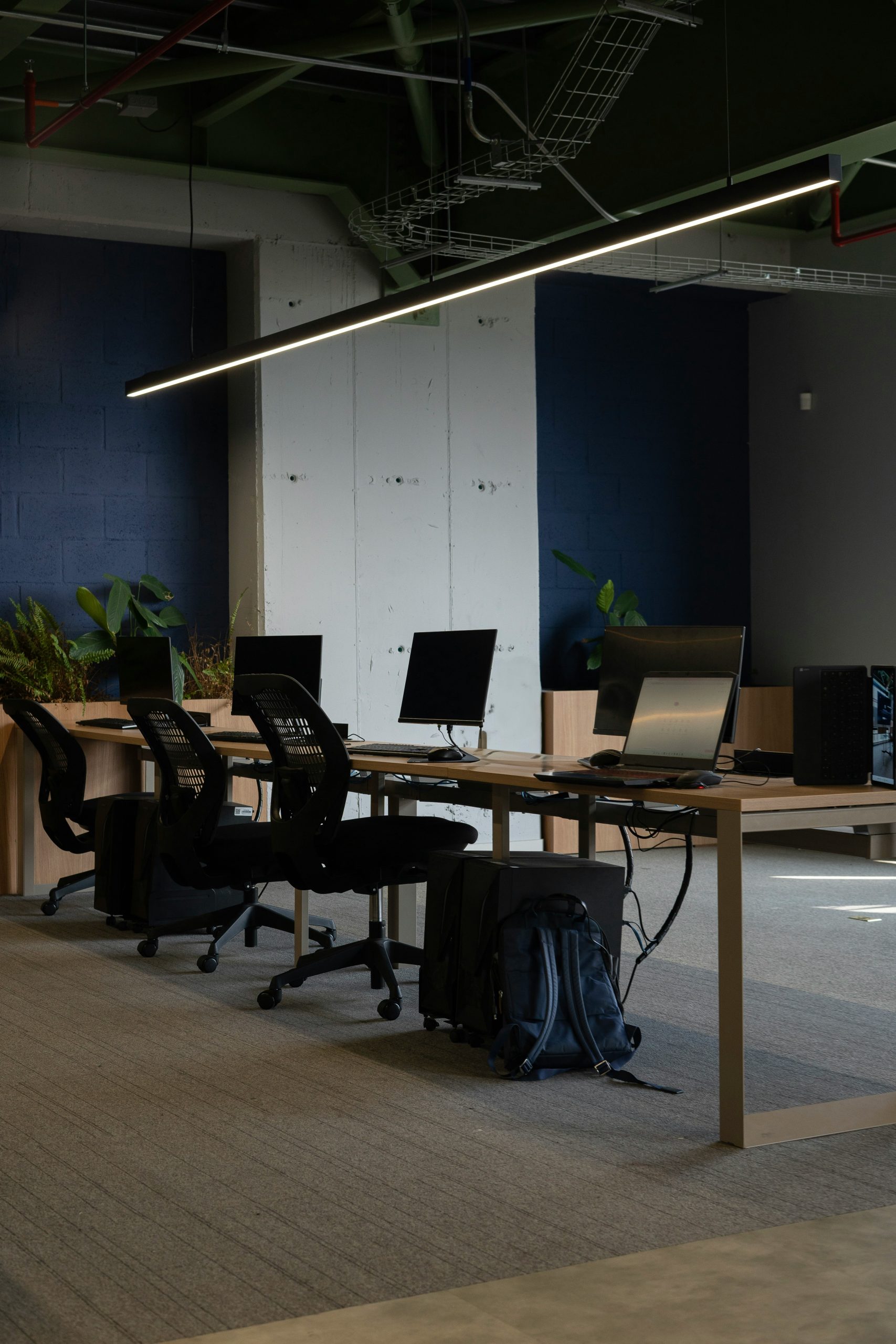 An empty office with a long table and chairs