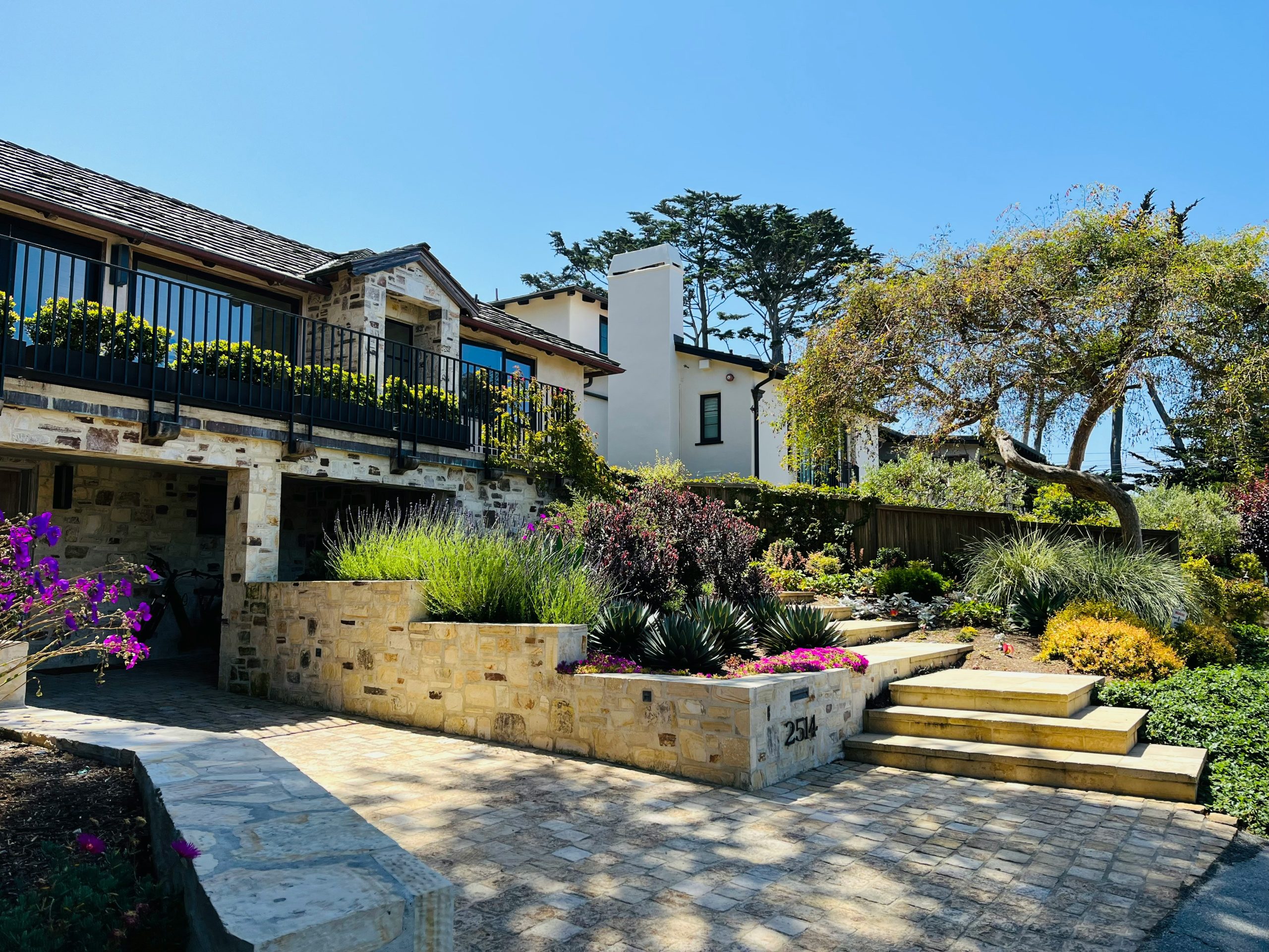 Beautiful house with stunning landscaping under a blue sky