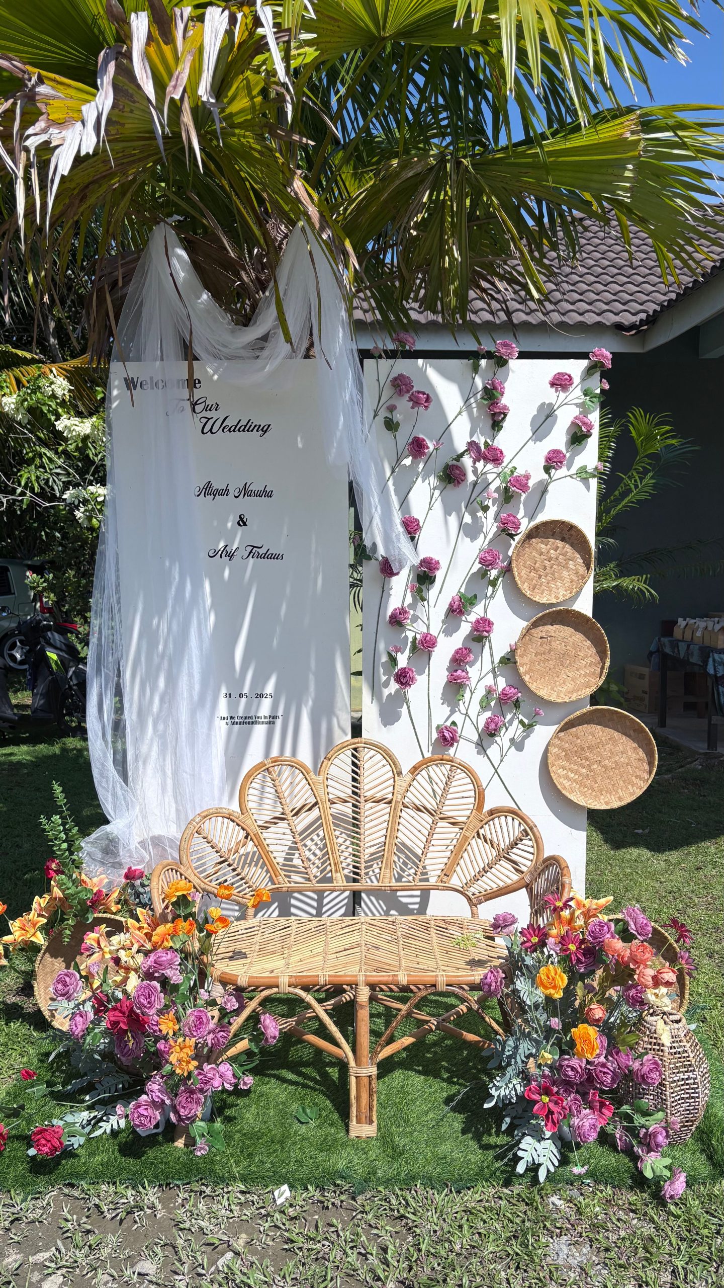 Beautiful outdoor wedding decoration with rattan furniture and floral accents in Terengganu, Malaysia.