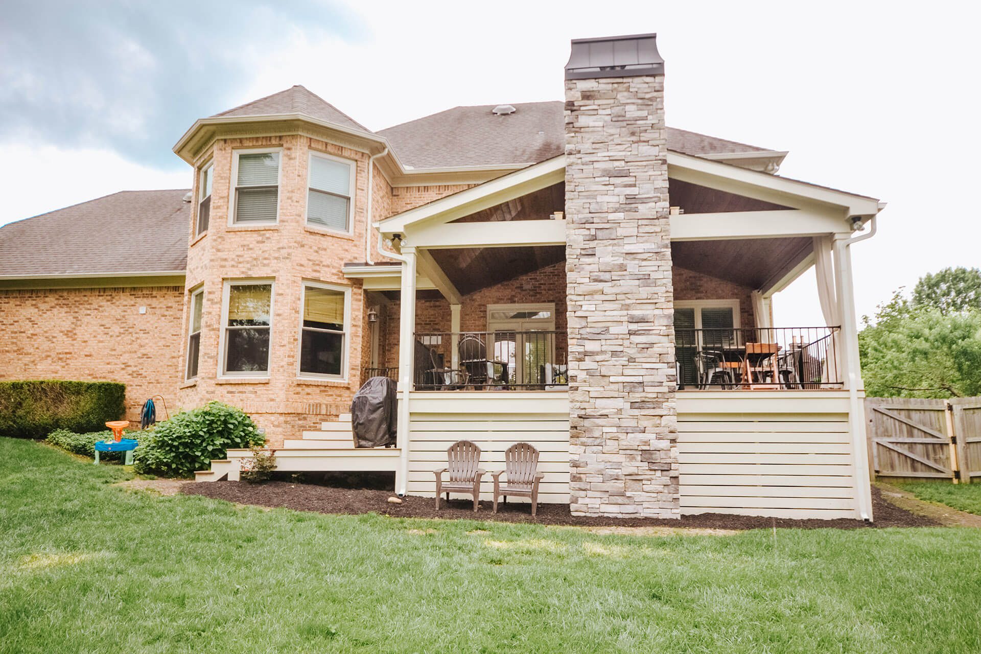 Cozy Outdoor Living: Covered Deck With Fireplace Extends Living Space For Westmoreland Family - McCamy Construction | McCamy Construction