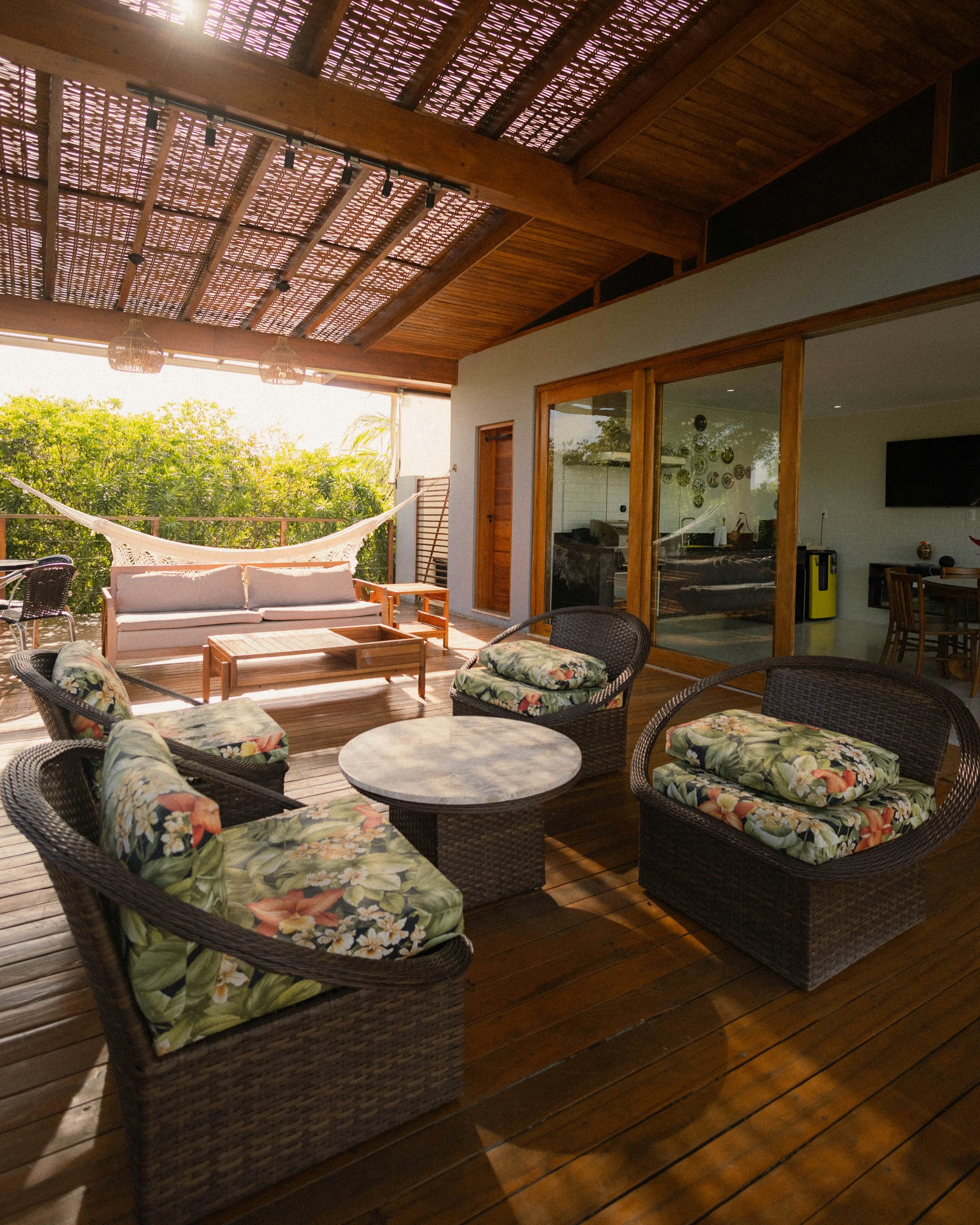 Cozy patio furniture with a hammock and tropical plants
