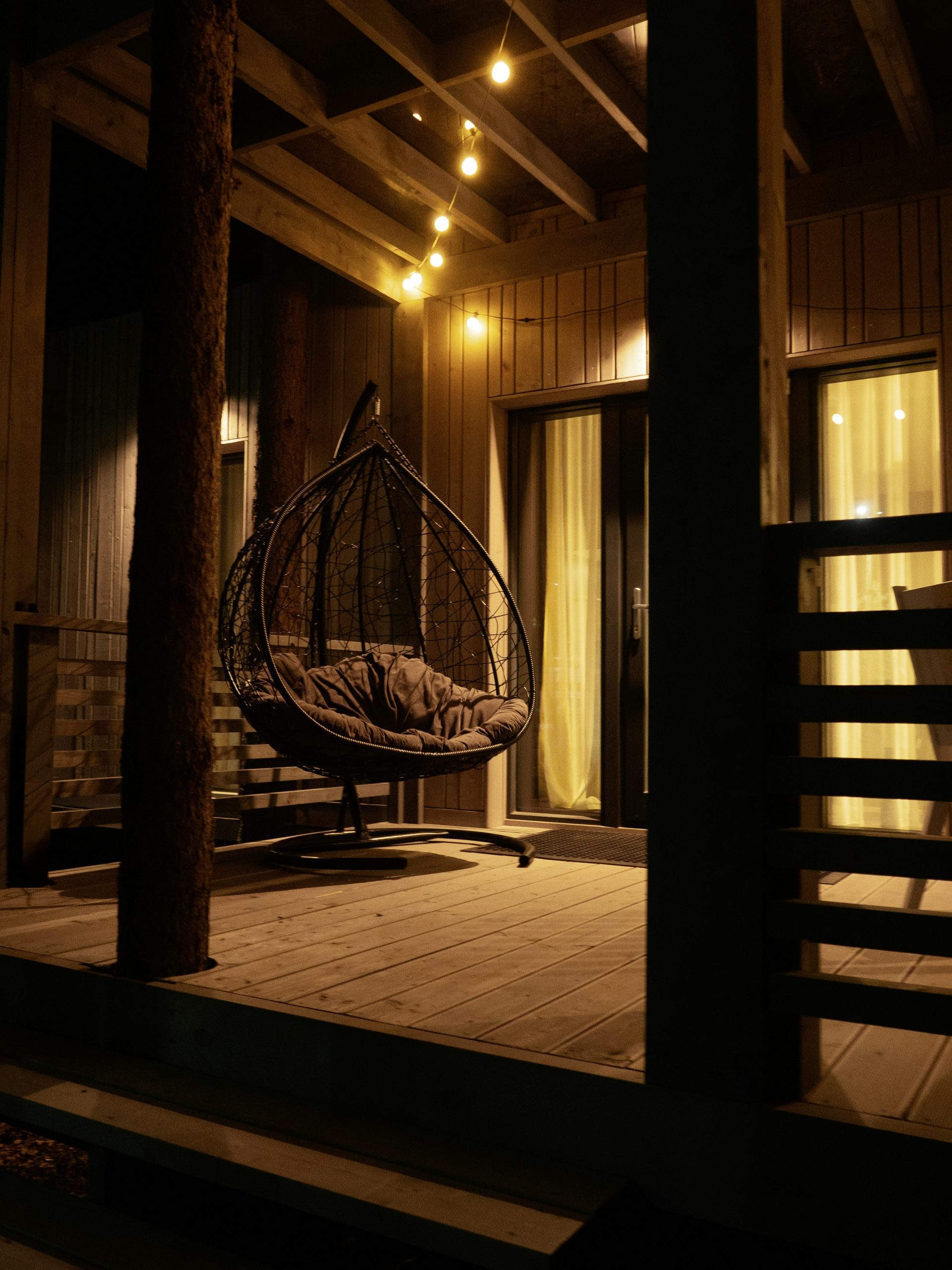 Discover the enchanting ambiance of a cozy terrace at night, aglow in the warm embrace of twinkling fairy lights. This charming outdoor haven beckons you to unwind and savor the tranquil beauty of the