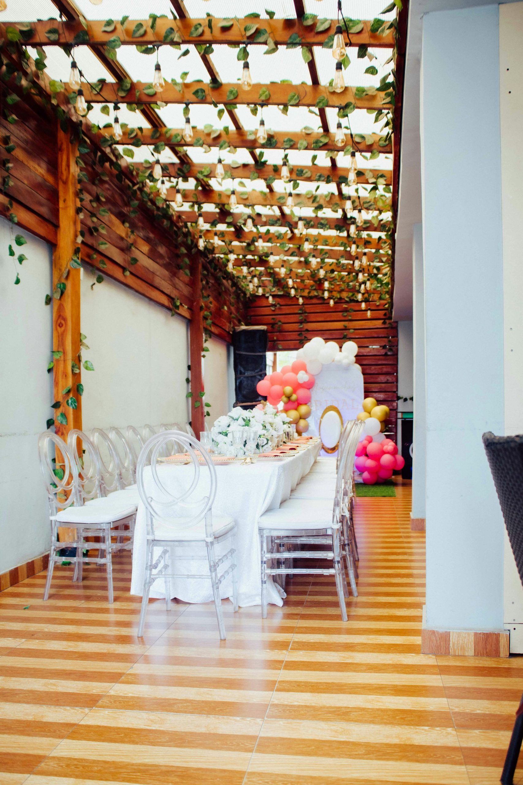 Elegant outdoor event space with decorated table and balloons