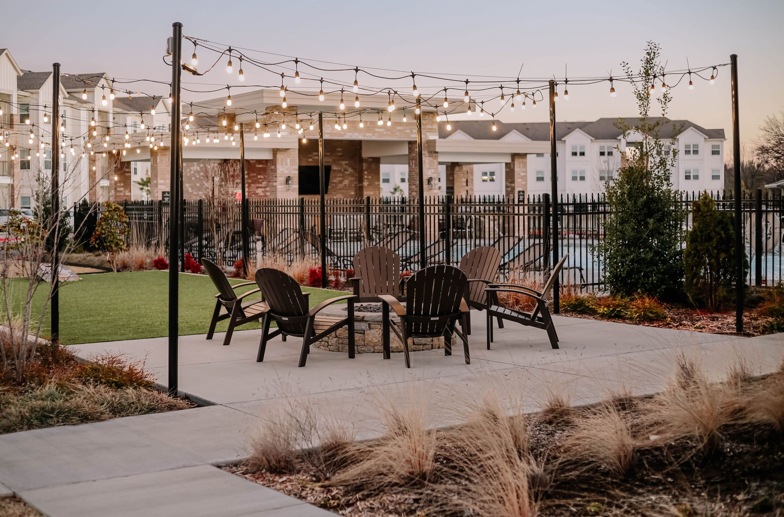 Elegant outdoor patio with string lights and chairs, perfect for evening gatherings.