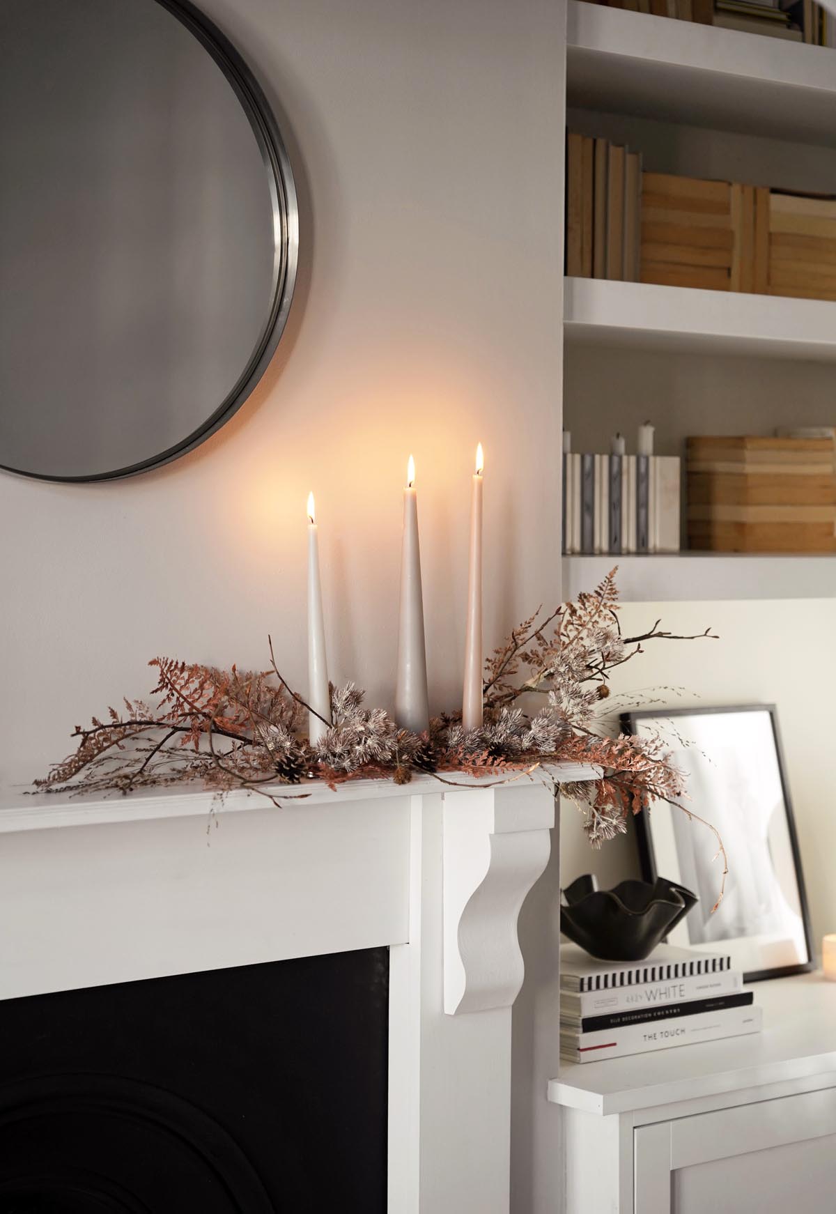 How to create a festive mantelpiece display using branches and dried foliage |