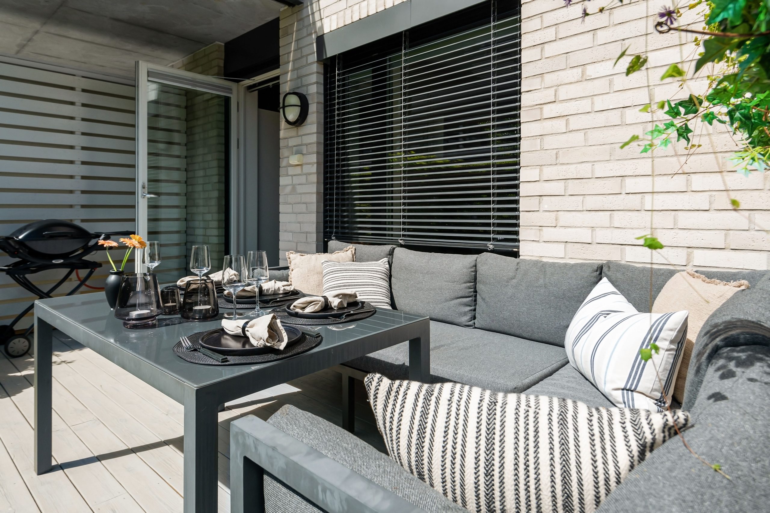 Modern outdoor patio with contemporary furniture, perfect for summer relaxation.