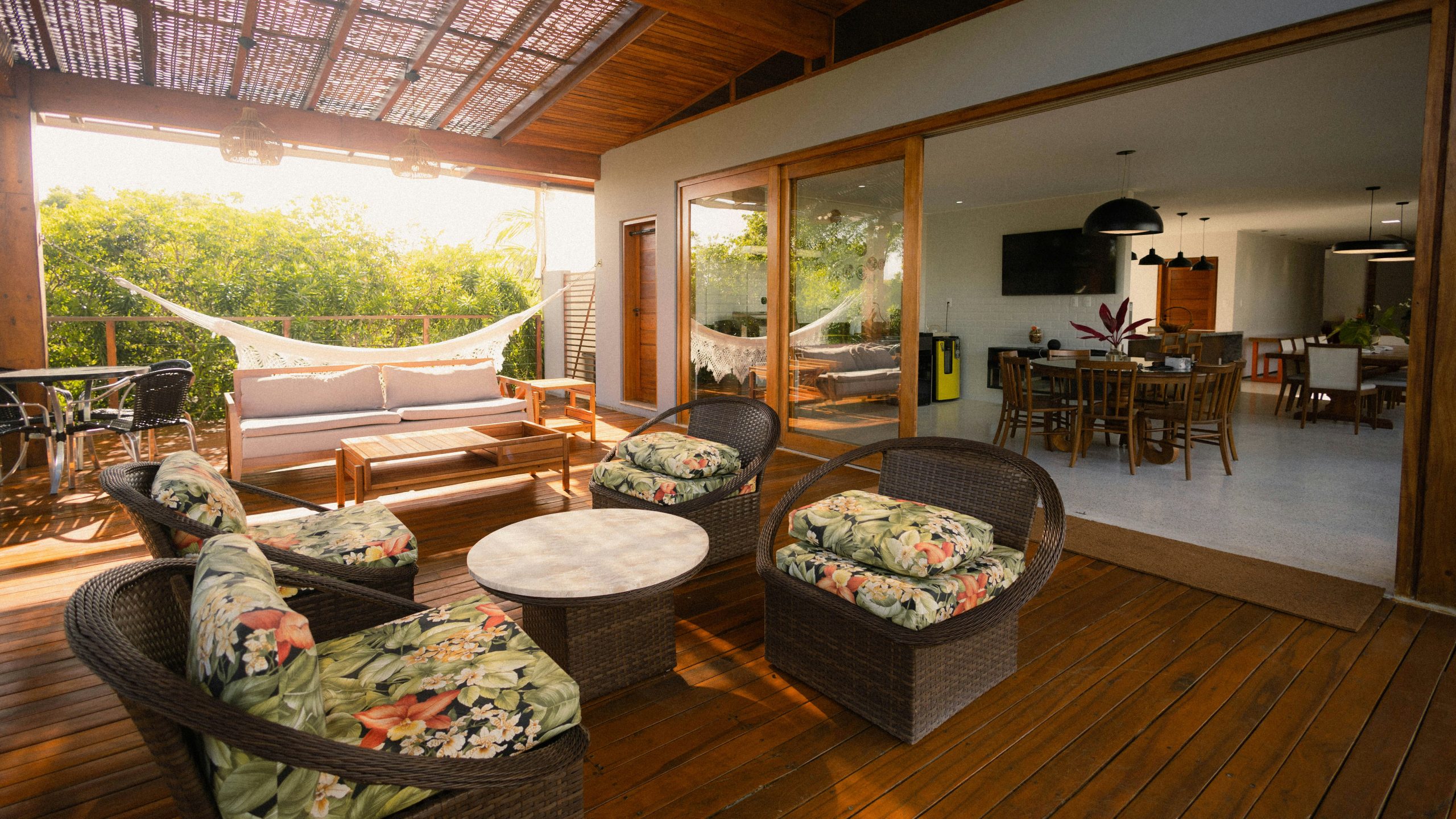 Outdoor patio seating area with a hammock and dining room