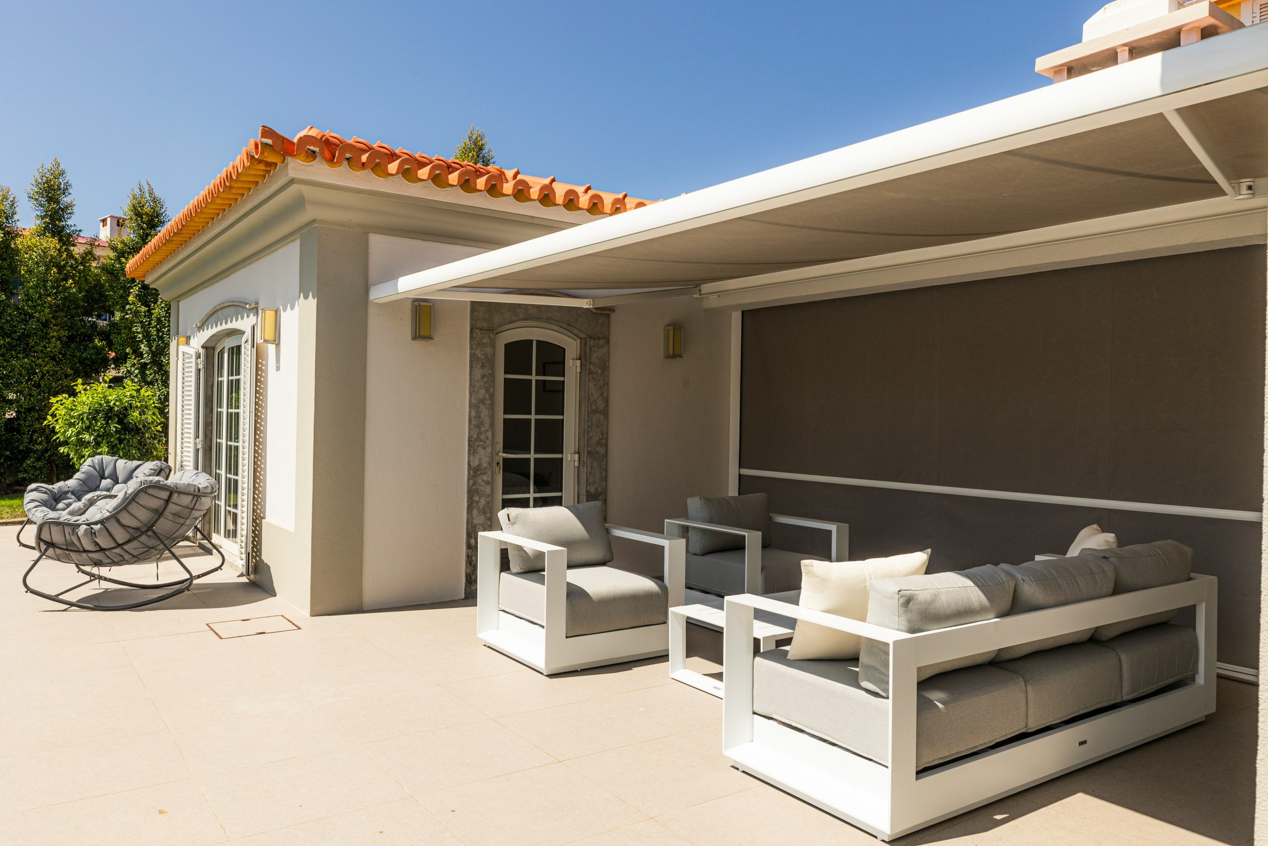 Outdoor patio with stylish seating and awning