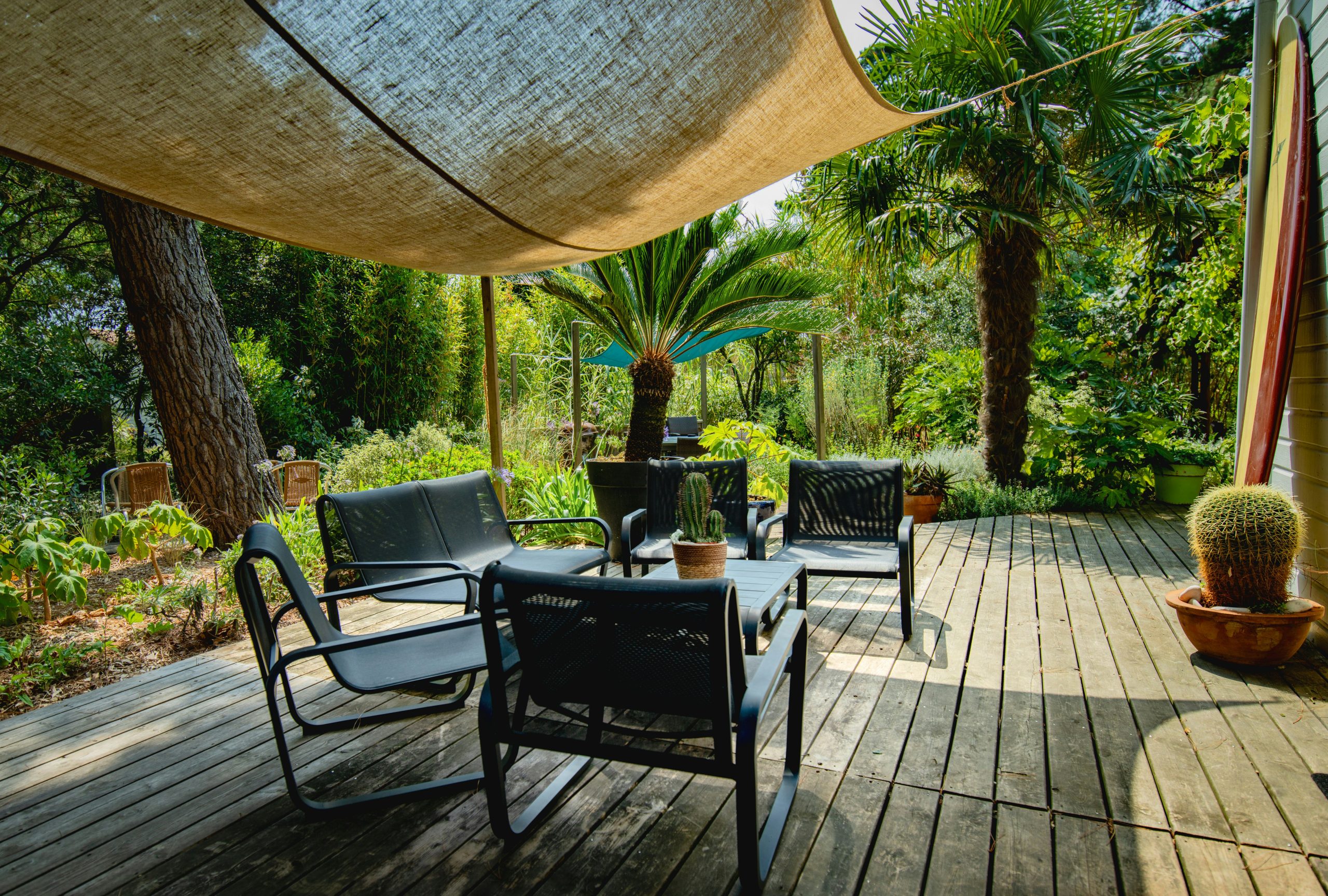 Outdoor seating area with chairs and table under canopy