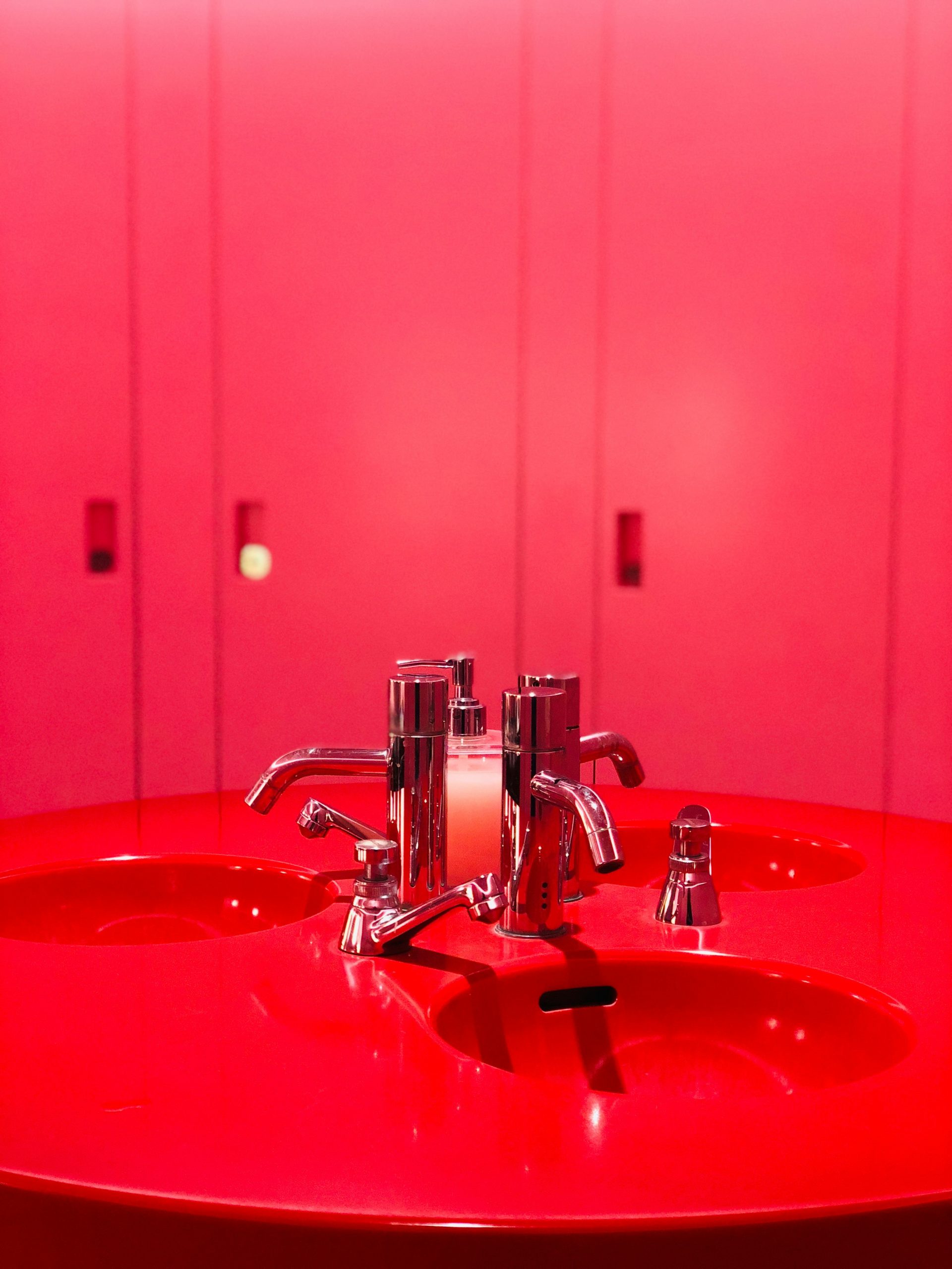 red ceramic sink with stainless steel faucet