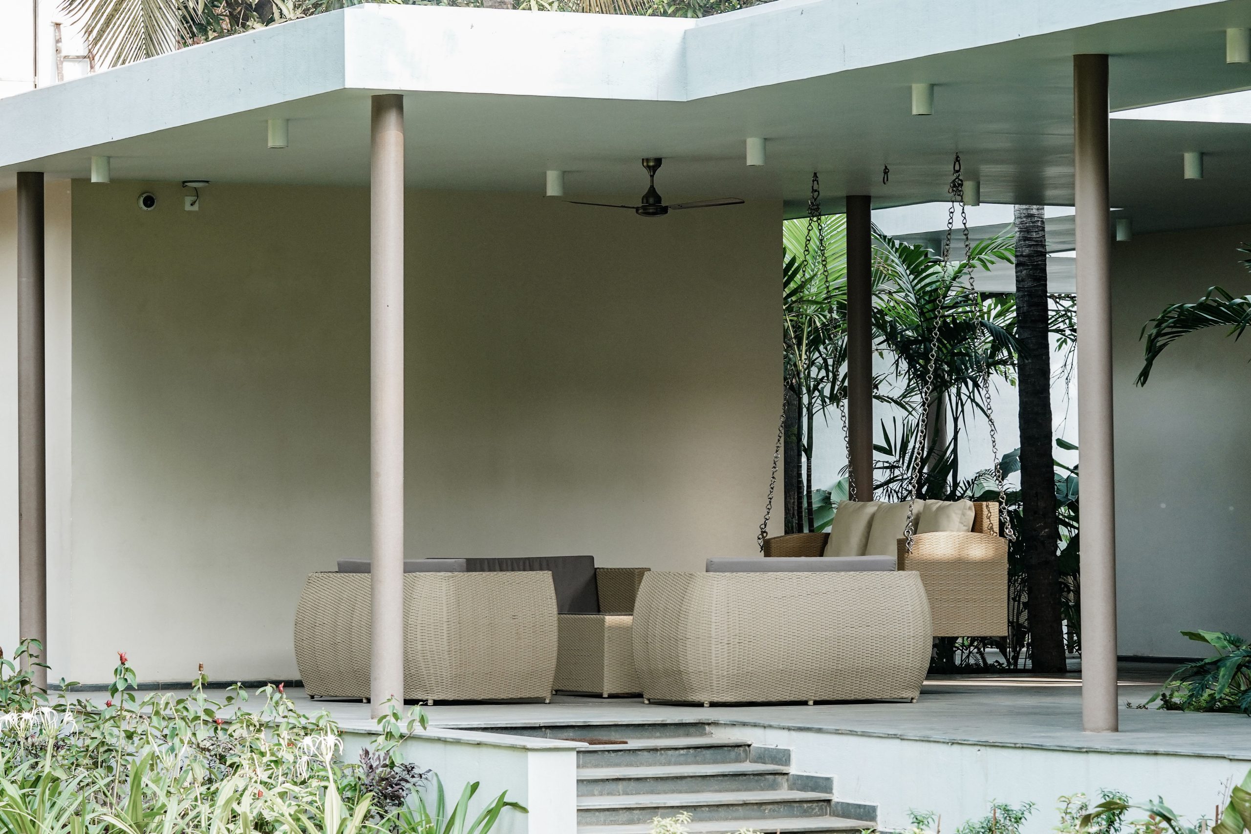 Spacious outdoor patio with modern wicker furniture, perfect for relaxing summer afternoons.