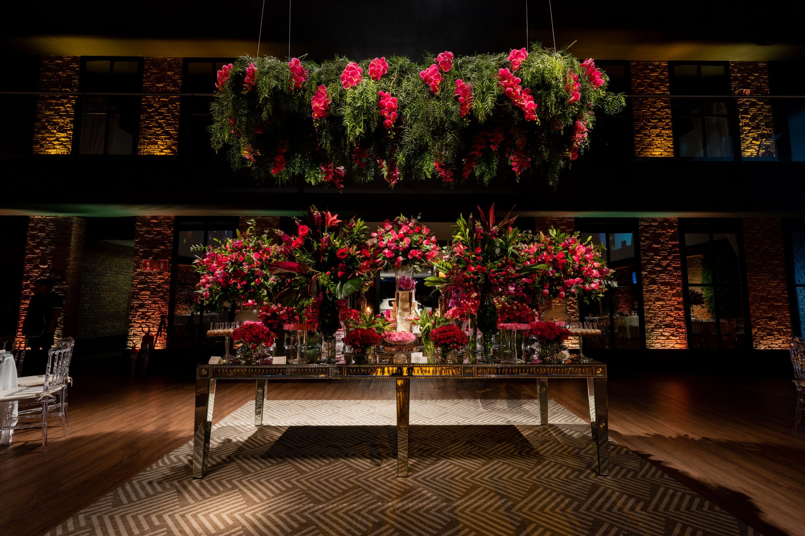 Stunning wedding reception with flowers and elegant table setup in an indoor venue.