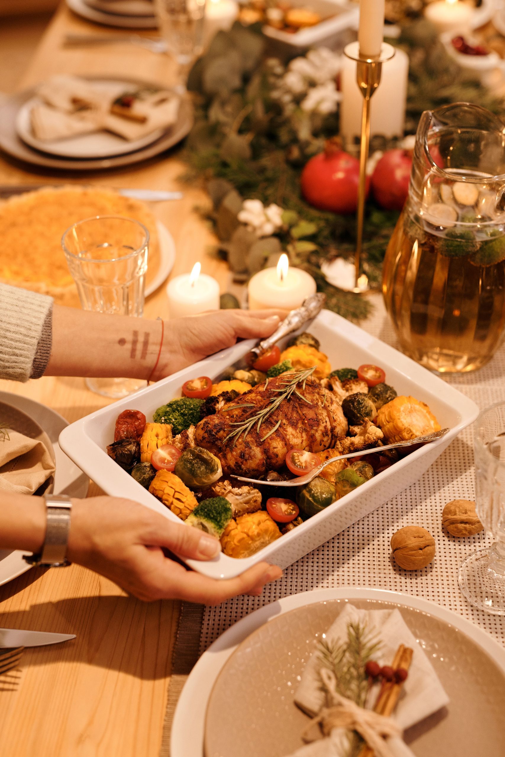 Warm, inviting holiday table setting with roasted chicken and Christmas decor.