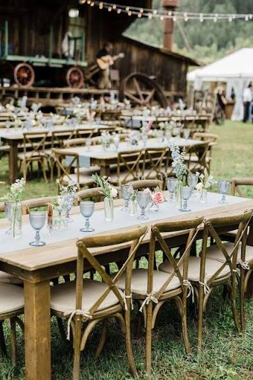 Wood Table With Simple Blue Runner, Goblets and Flowers at Rustic Rehearsal Dinner