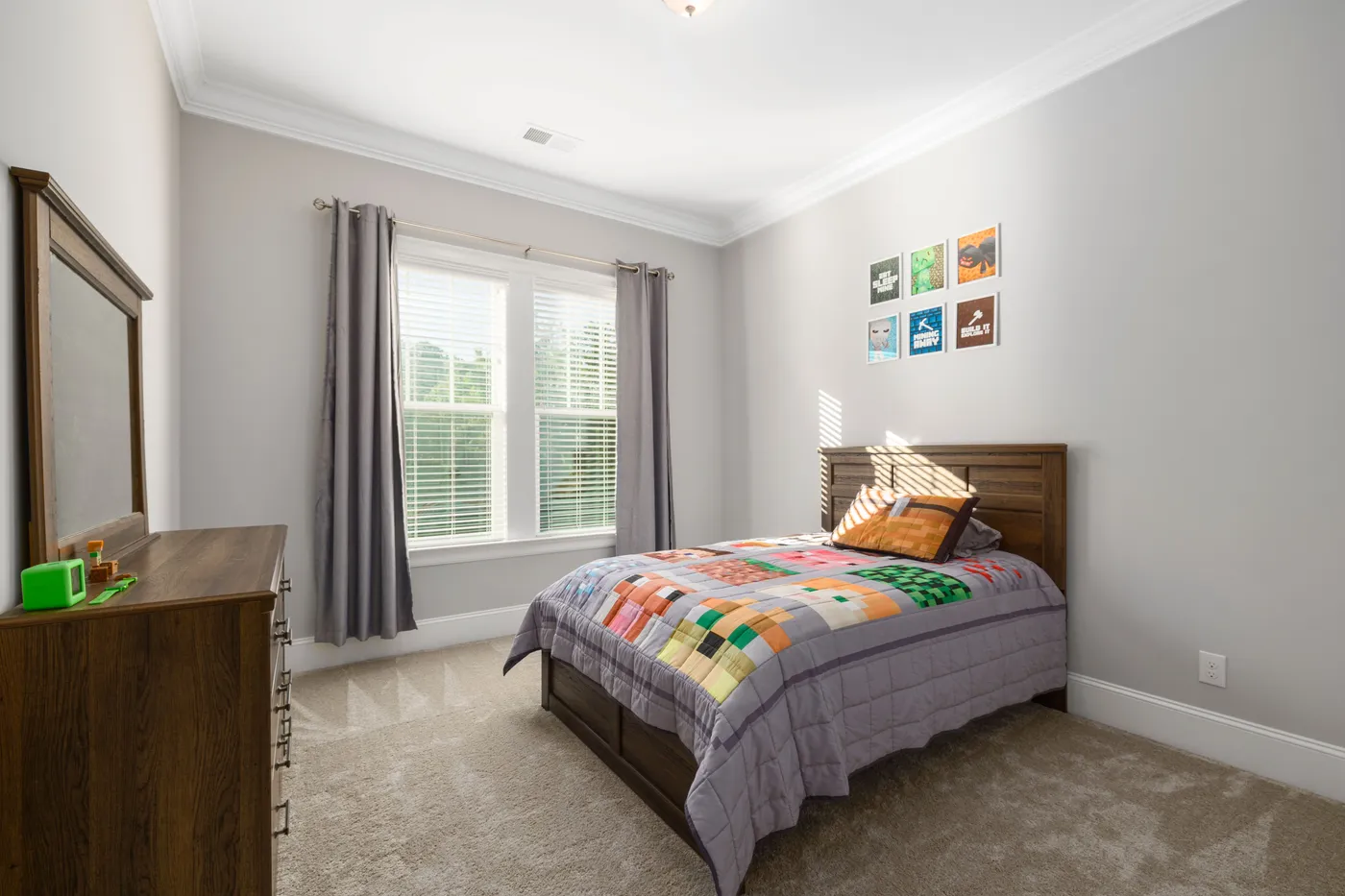 A bright and cozy bedroom with a colorful bedspread, perfect for modern interior design inspiration.