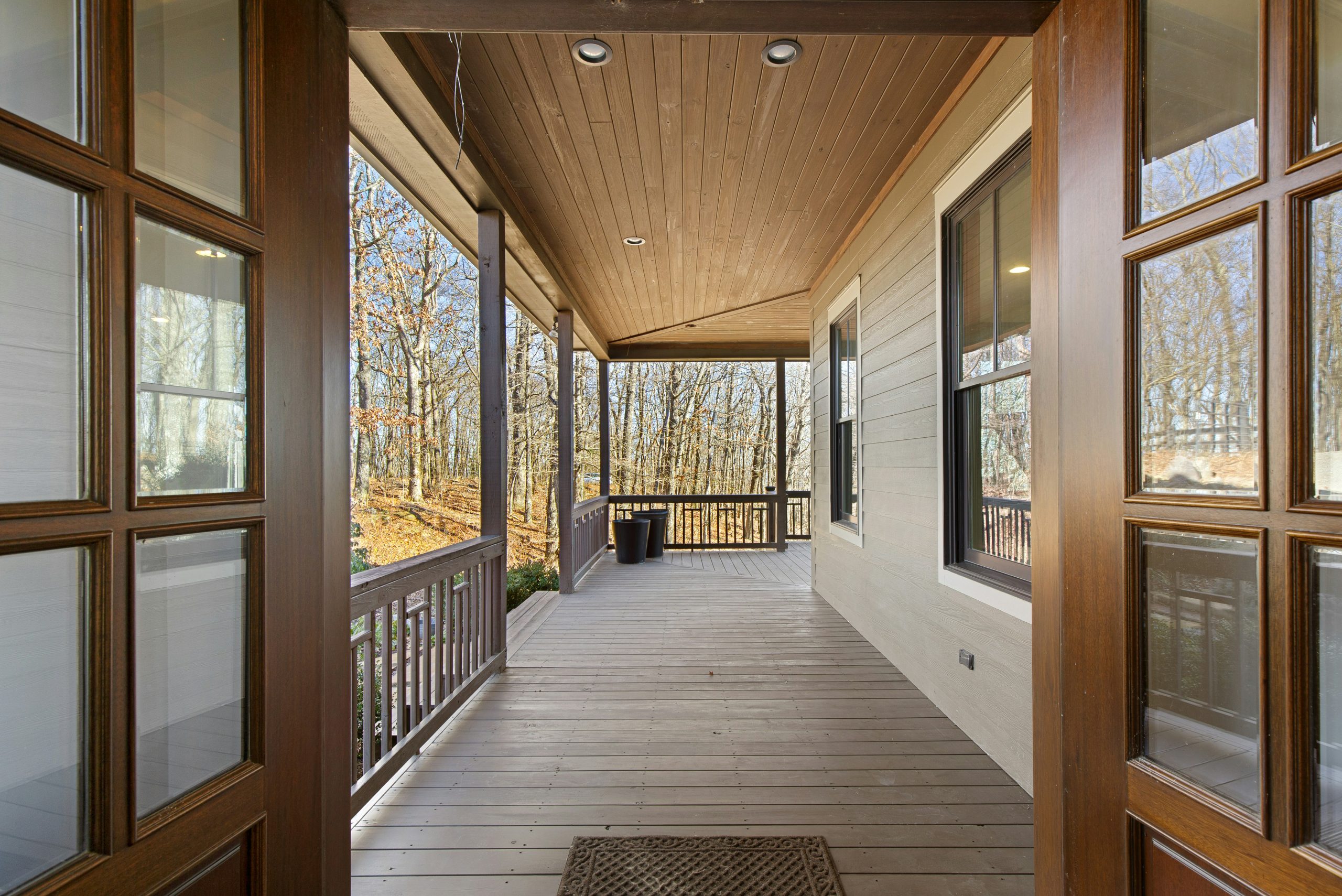 A long wooden walkway with windows on both sides