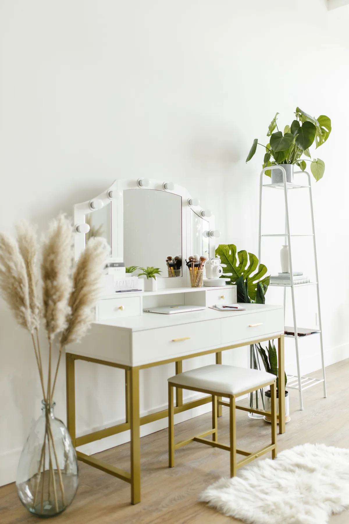 A modern vanity table with plants and decor, showcasing minimalist home interior design style.