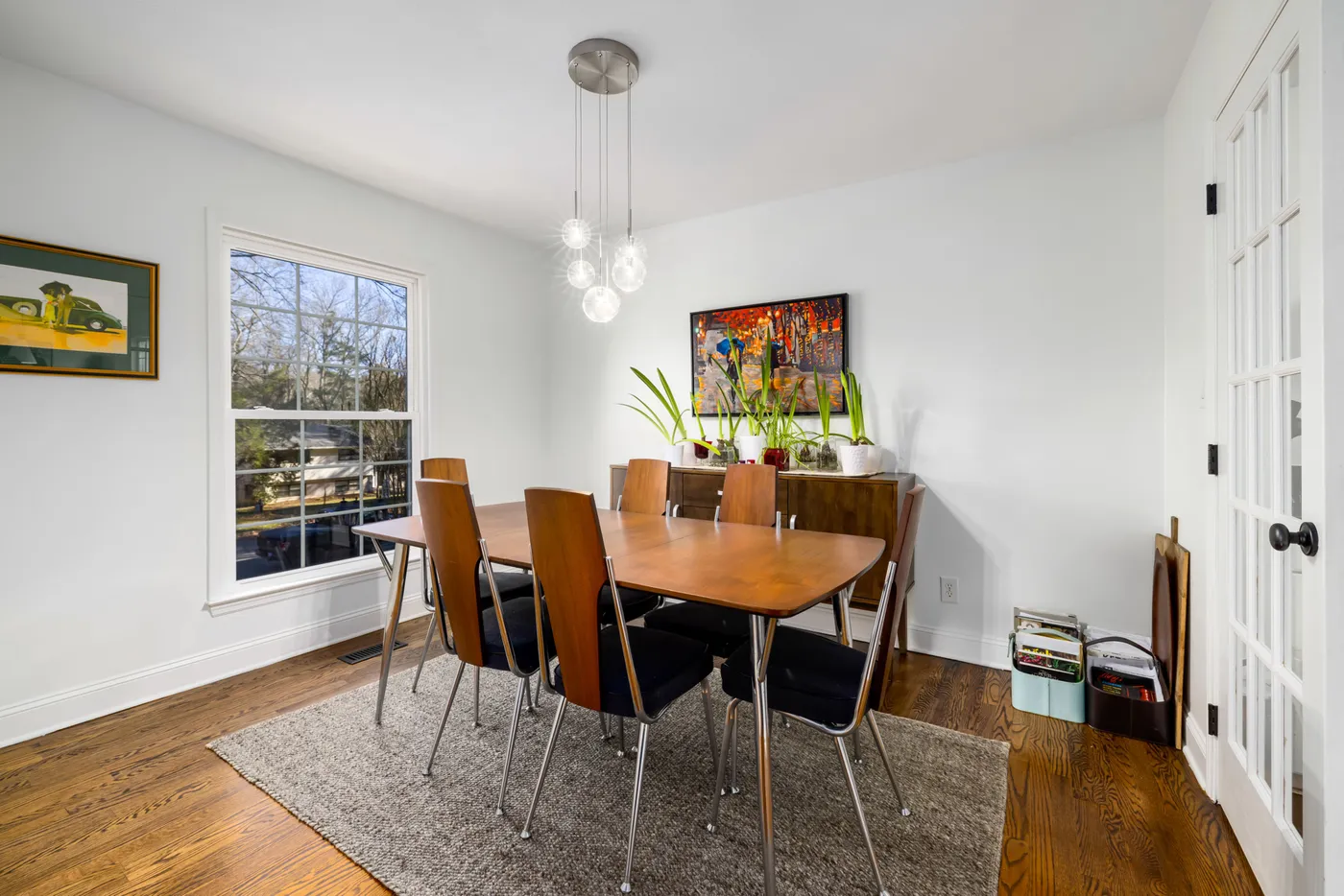 Bright modern dining room with wooden table and contemporary design.